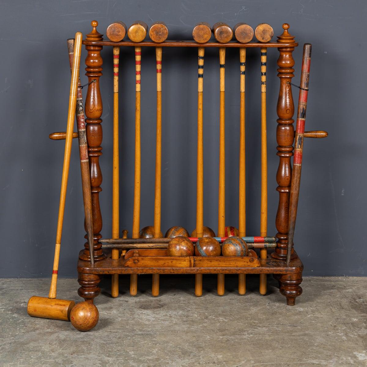 Antique 19th Century Victorian set for eight people, made by Cassiobury in the 1880's. This set includes eight mallets, eight striped wooden balls, four pegs, nine hoops and a hoop drill, all contained within a neat wooden stand. A superb gift and a