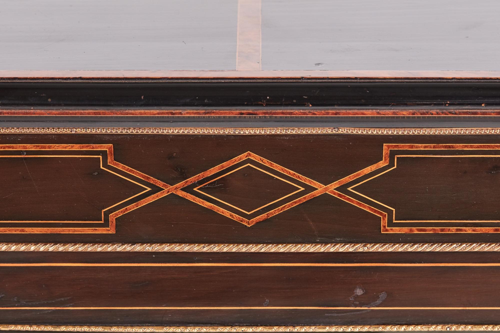 Antique 19th century Victorian ebonized and inlaid display cabinet with a pretty inlaid amboyna top, frieze, plinth and sides. One large glazed door to the front and two inlaid columns with ormolu mounts. It stands on a plinth base with original