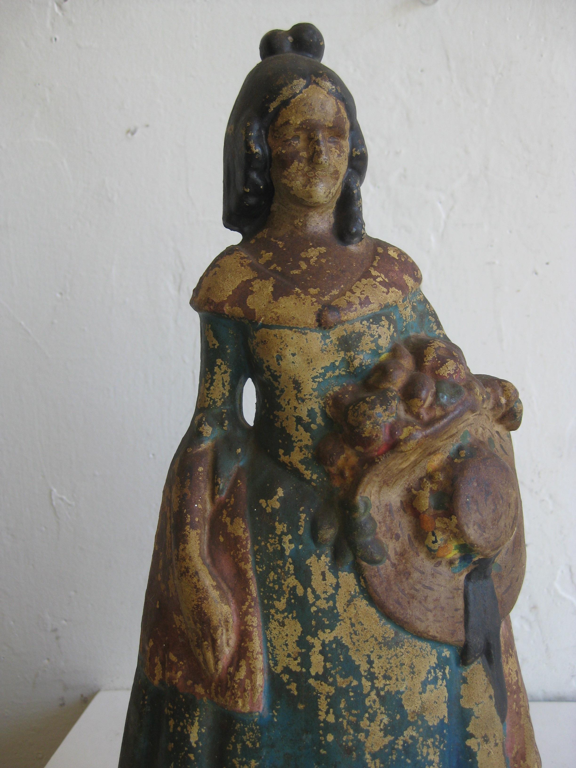 Great original Victorian era Folk Art cast iron hand painted polychrome figural lady doorstop. Dates from the late 1800s. Features a woman holding a straw hat. Has the remains of the original paint. Great patina and displays well. No cracks or