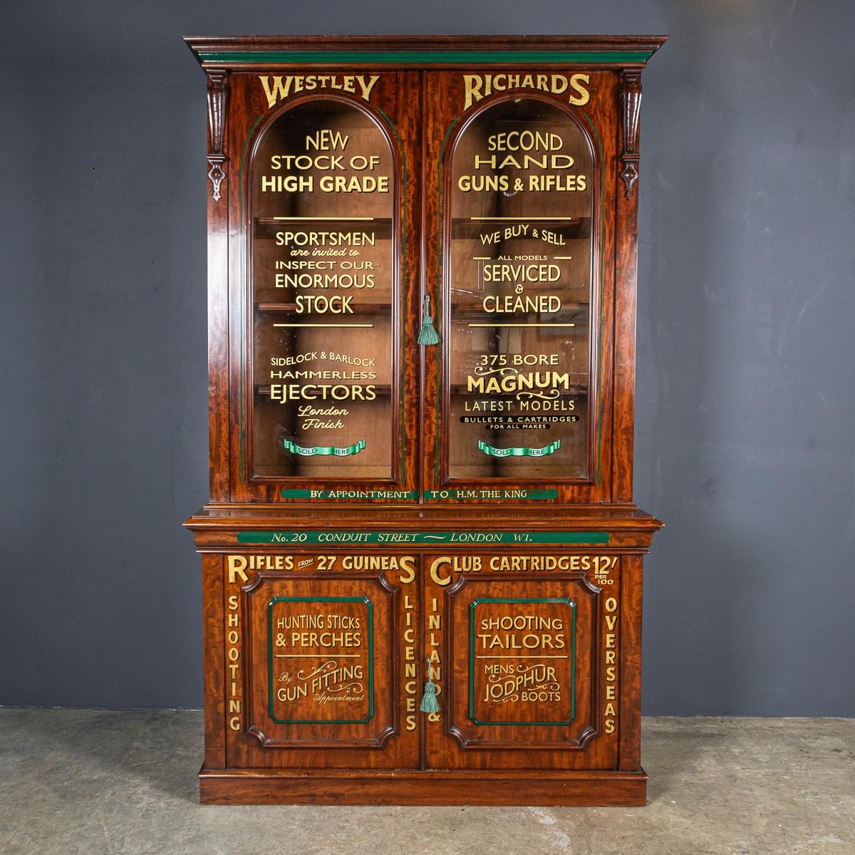 Antique late 19th Century Victorian mahogany glass fronted display cabinet, later painted for use in a gentleman's gun shop based in London. This stunning piece of British craftsmanship has been beautifully later painted with gold lettering on glass