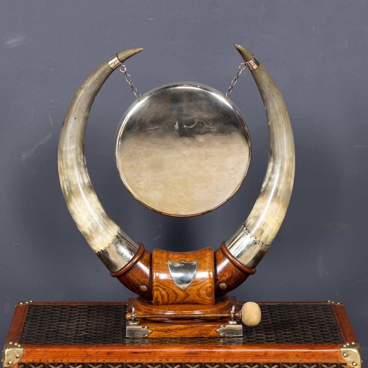 Antique 19th Century large silver-plated dinner gong, suspended from metal chains between two polished cattle horns on an oak stand. It includes the original striker and features a blank crest in the centre, perfect for engraving initials. This