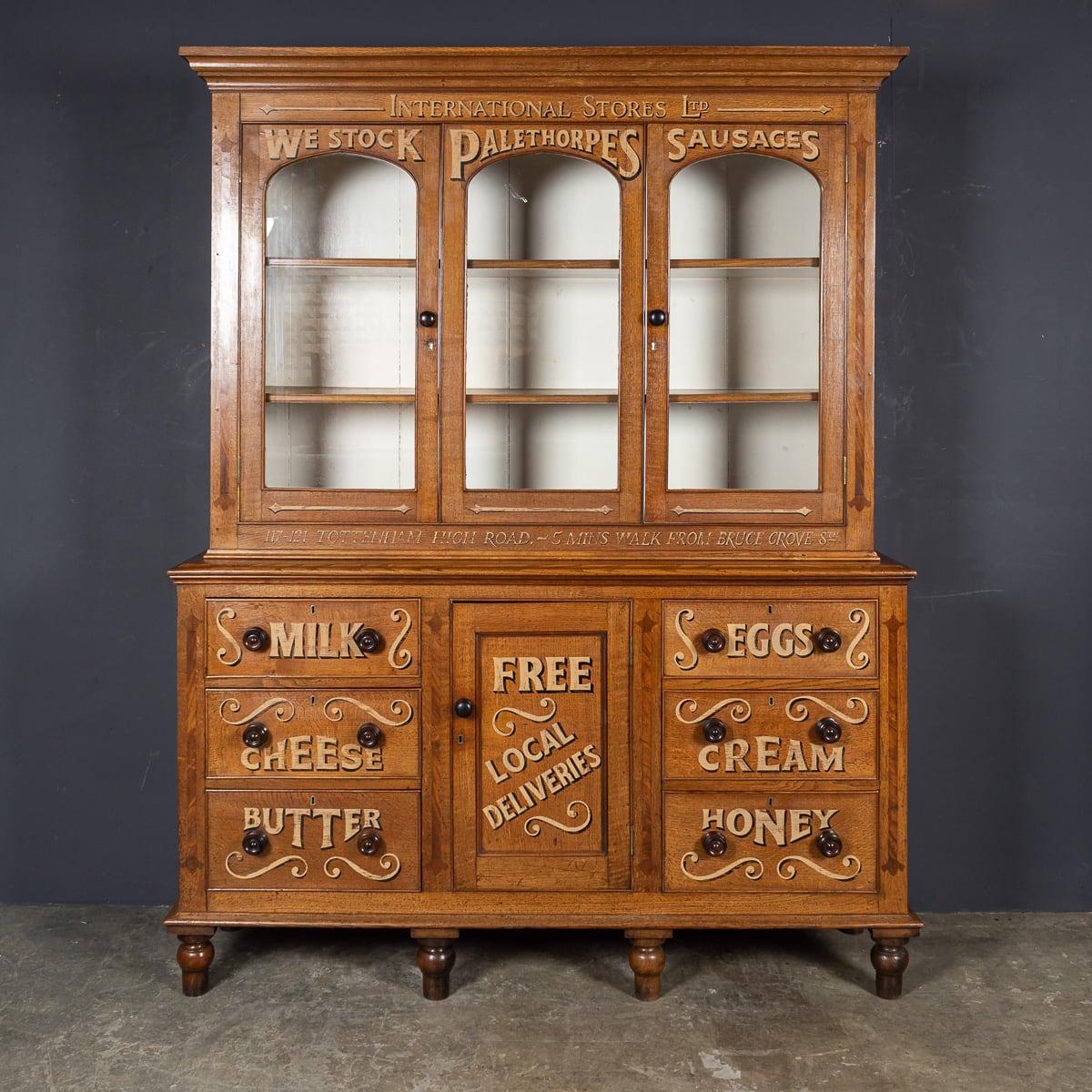 Antique 19th Century Victorian oak dresser with three glass-fronted display doors and a cupboard, complemented by three drawers on each side below, all resting on turned feet. This piece has been later painted for use in a local dairy.

CONDITION
In