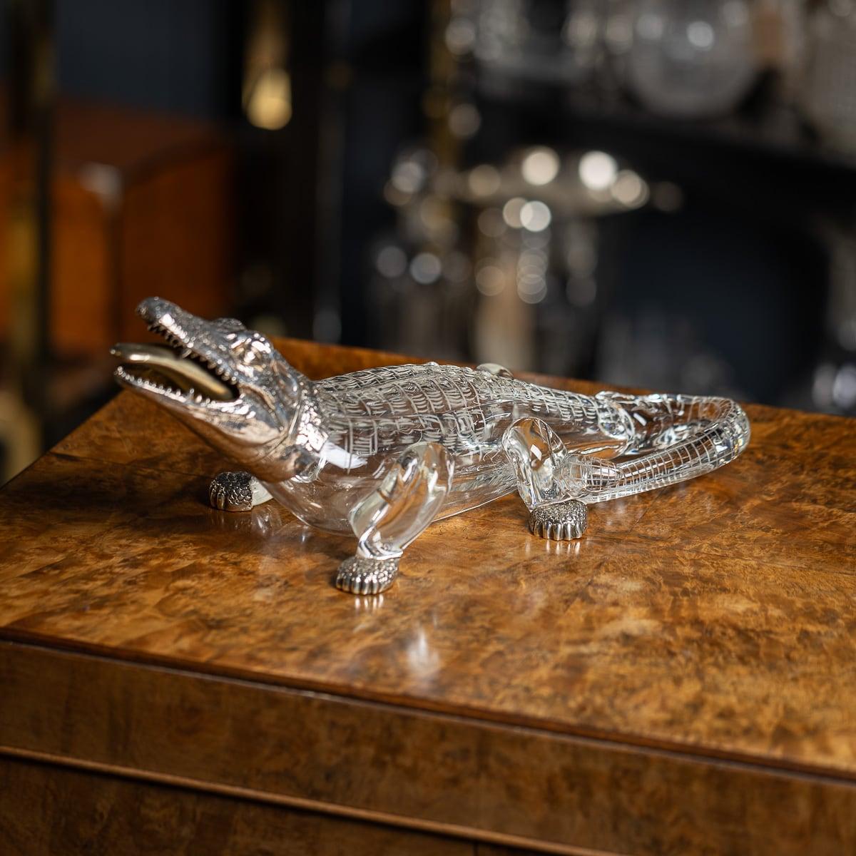 Antique 19th Century Victorian solid silver & glass crocodile shaped claret jug. The glass body is adorned with legs, and a tail, all intricately engraved with protruding scales. It is mounted with textured silver feet, and the realisticaly modeled