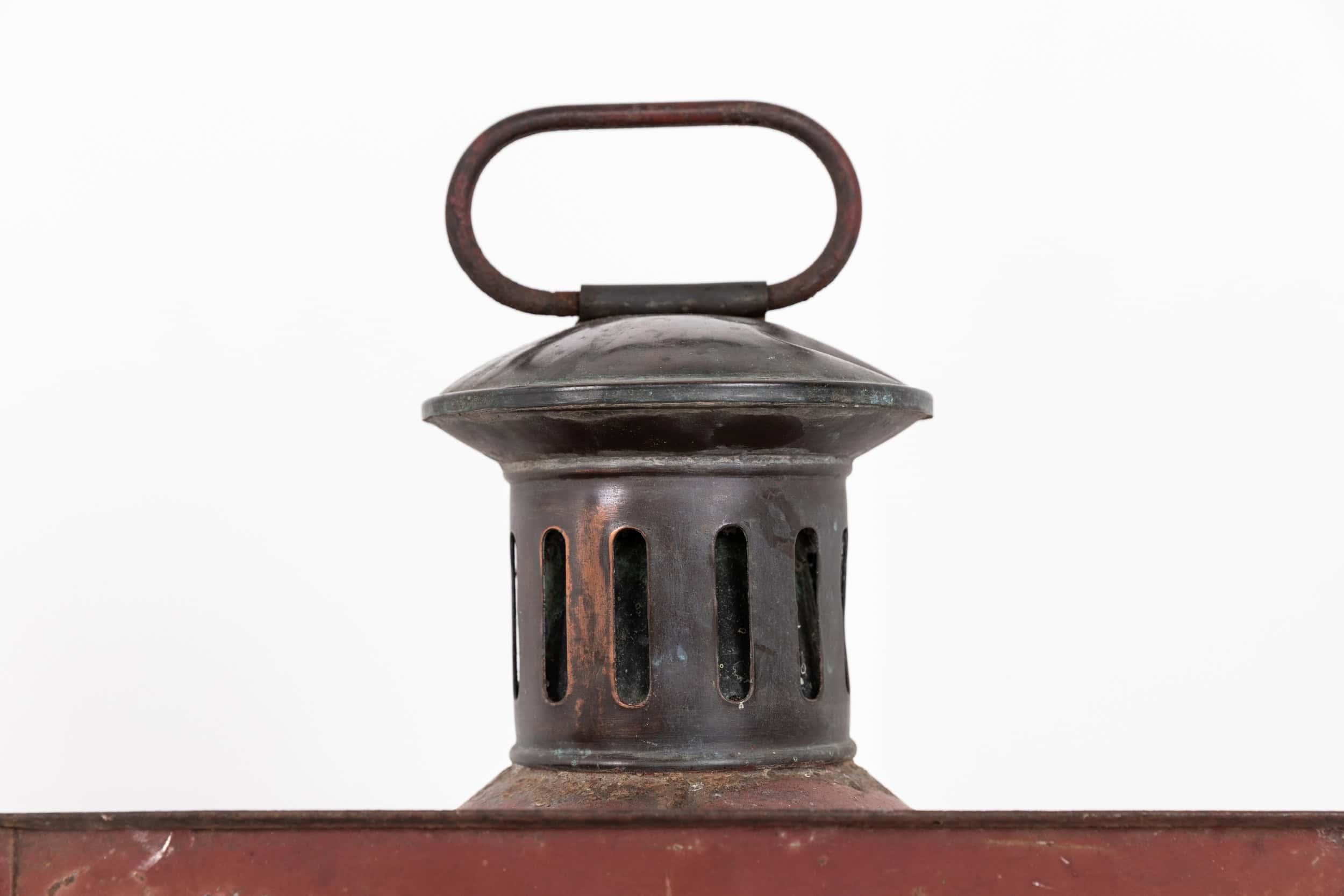 

An unusual and large late 19th century painted toleware lantern. c.1880

Perhaps originally from a railway environment with carry loop to the top. In it's original painted and perfectly patinated surface. This lantern can be wall mounted or floor