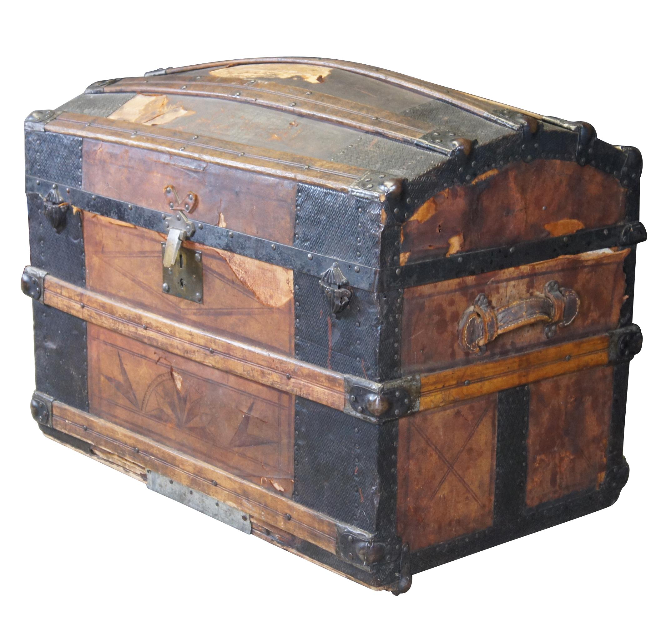A large and impressive Victorian era dome top steamer trunk, circa 1870s. Features a tooled leather and oak frame with geometric diamond pattern metal trim. Lock patented in 1876. 

