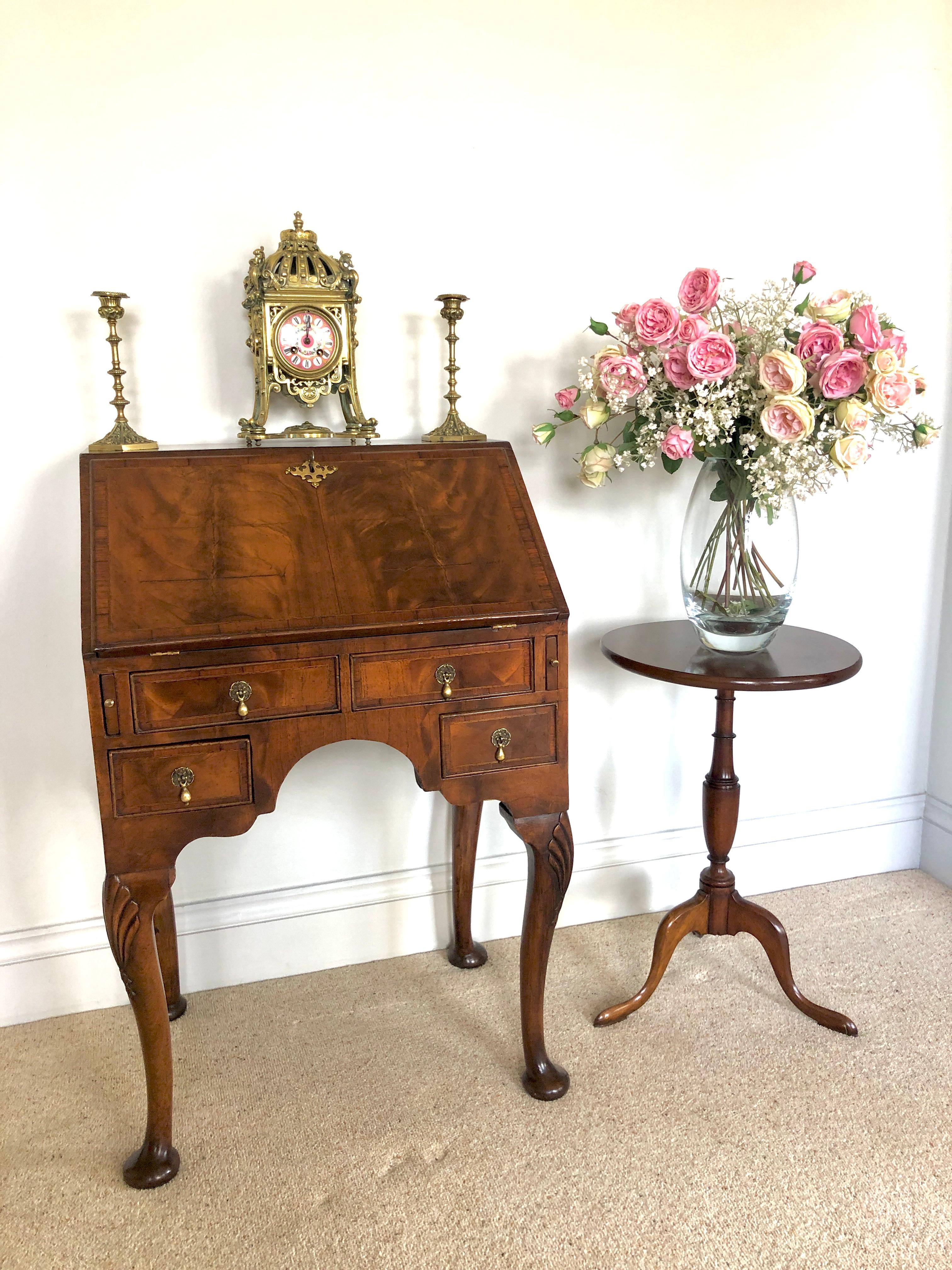 Antique Victorian figured walnut bureau having a figured walnut cross banded fall with original brass escutcheon opening to reveal a charming fitted interior consisting of two drawers, pigeon holes and a door to the centre, two long drawers below