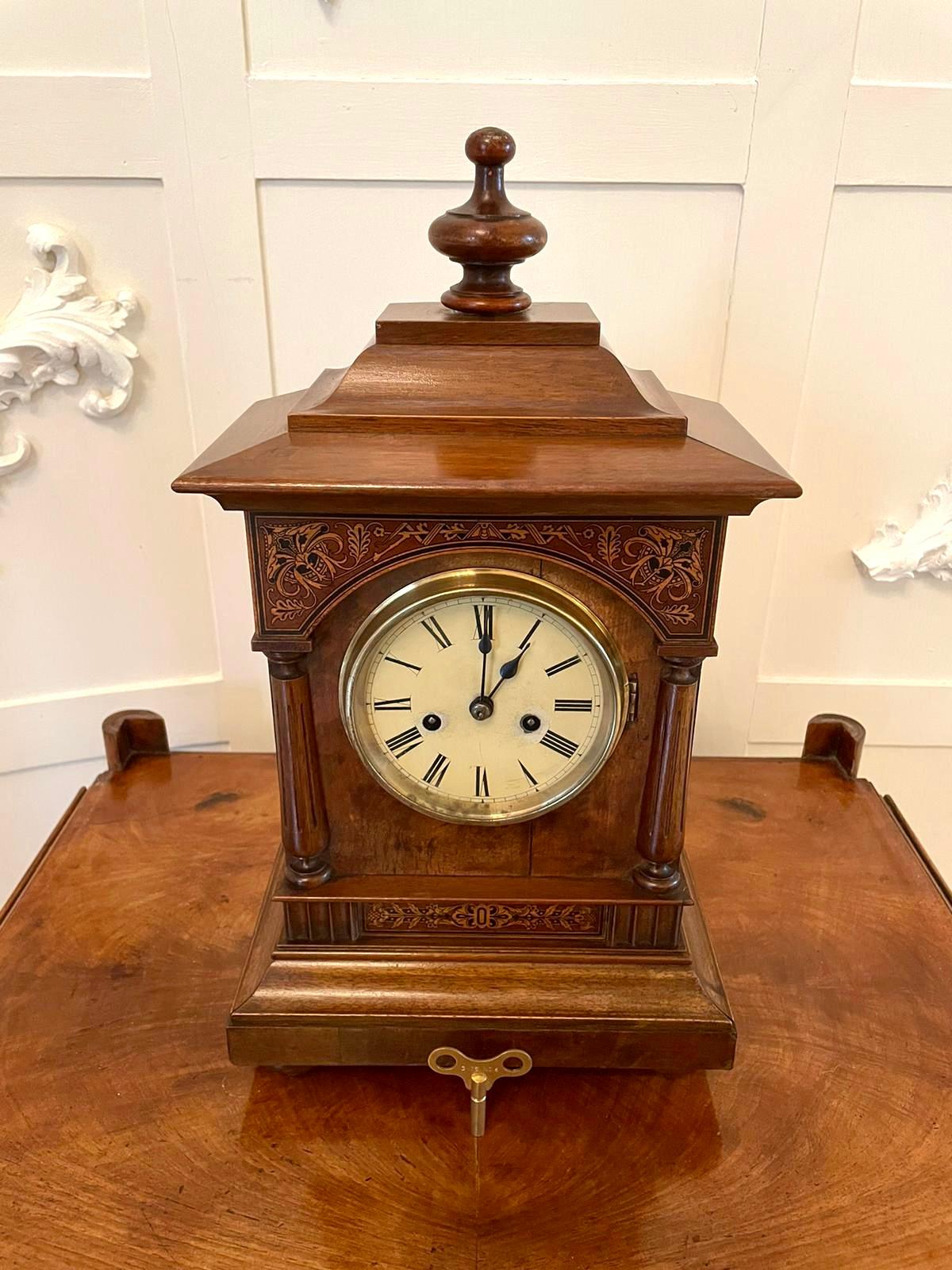 Antique 19th century Victorian walnut inlaid eight day mantel clock having a turned walnut finial to the attractive shaped top, a fantastic quality inlaid walnut case with two turned reeded columns, a brass bezel, pretty painted dial with original
