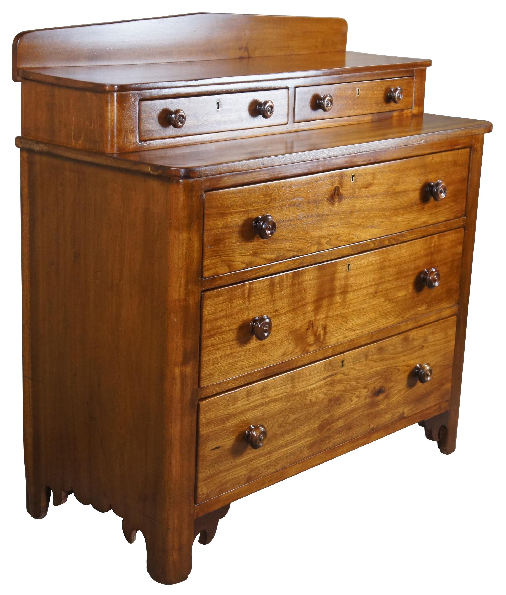 An eye catching American Victorian dresser, circa 1870s. A rectangular form made from walnut with an elegant step back design featuring two glove box or handkerchief drawers and a backsplash. Drawers are hand dovetailed with turned drawer pulls and