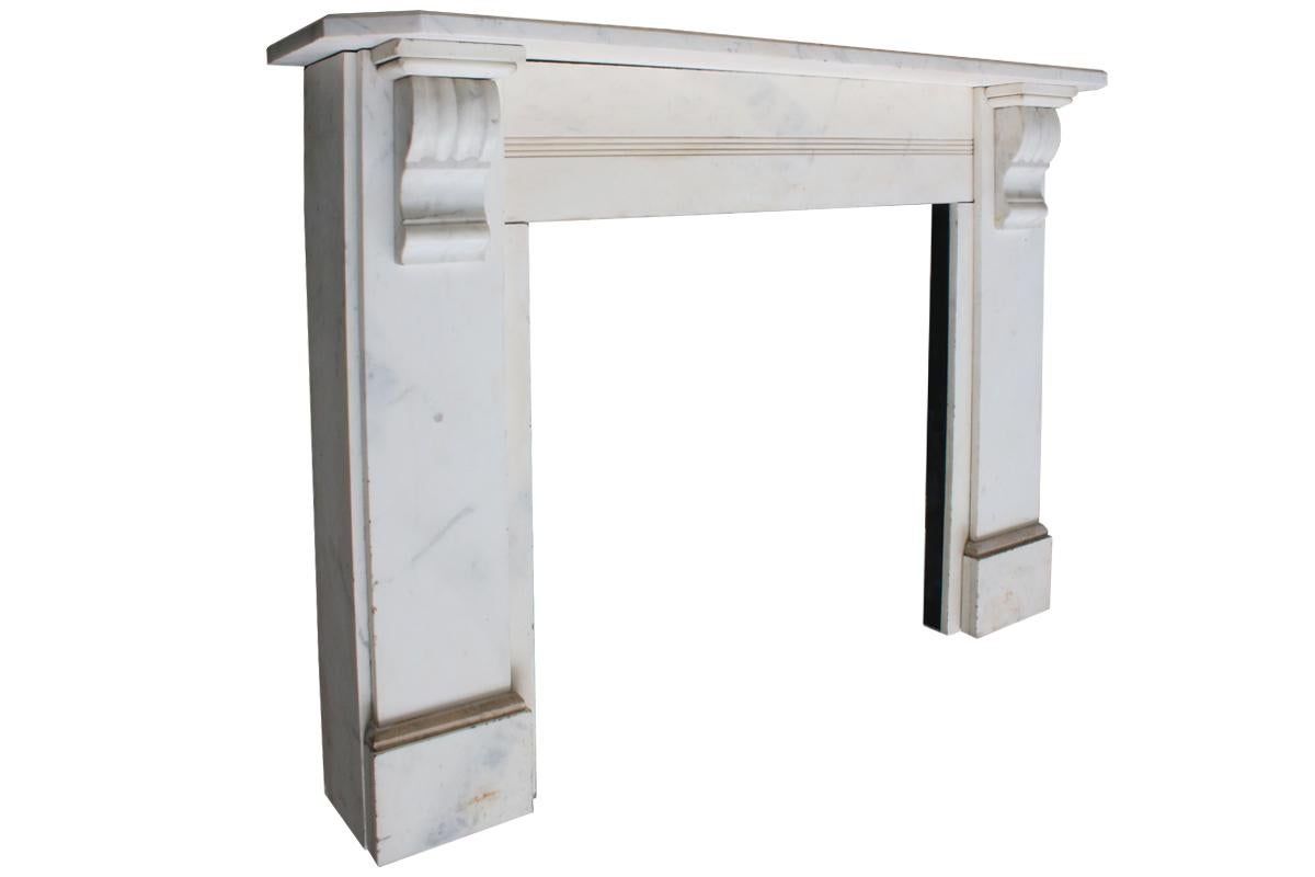 Antique 19th century Victorian white marble fireplace surround with carved corbels supporting the shelf and reeded detail to the frieze, circa 1860 

This fireplace is currently unrestored awaiting restoration.
