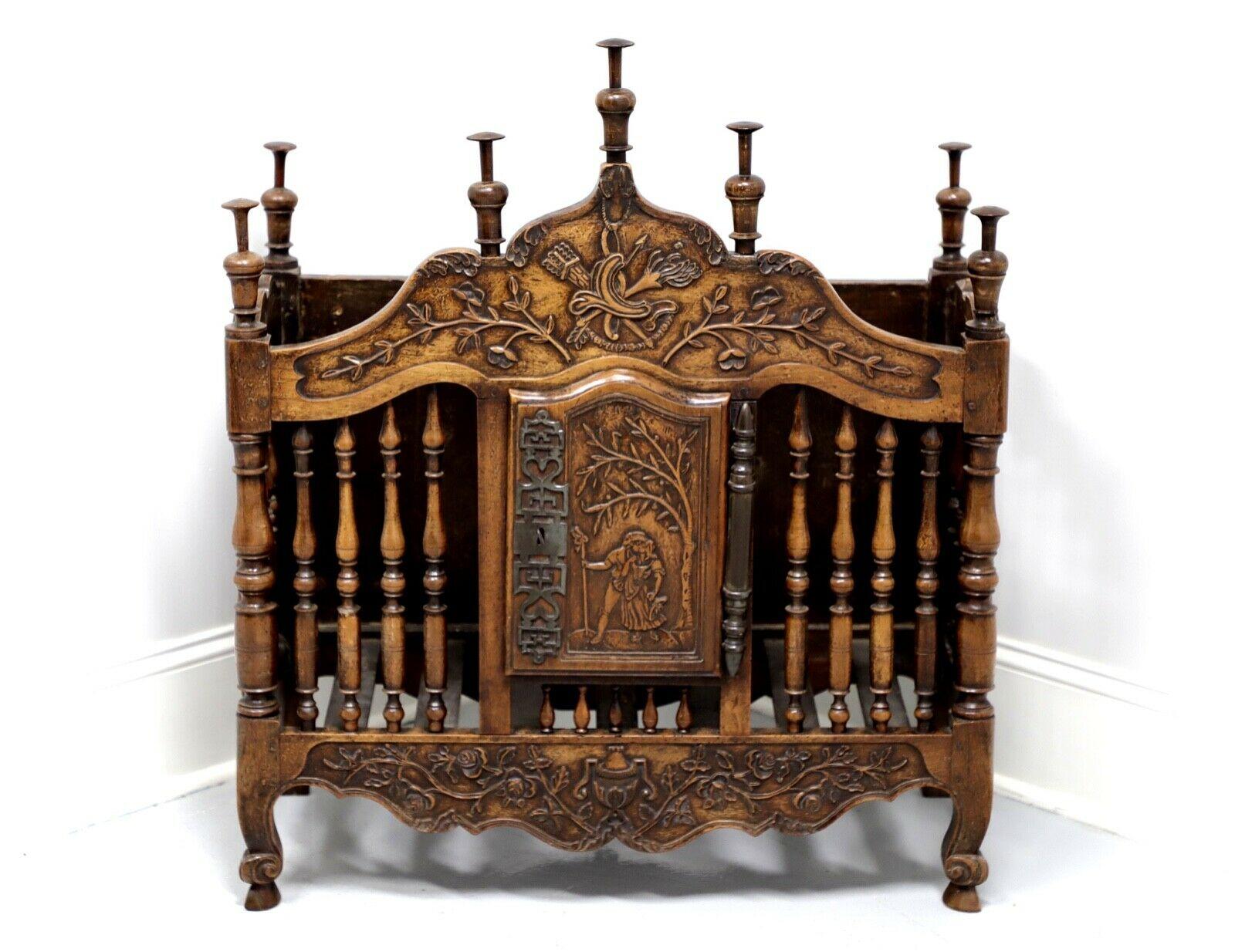 An antique 19th Century French Provincial panetiere, bread safe, unbranded. Walnut with metal hardware. Features decorative carvings to cornice, door & apron, turned spindles and decorative finials. Center door has working lock with one included