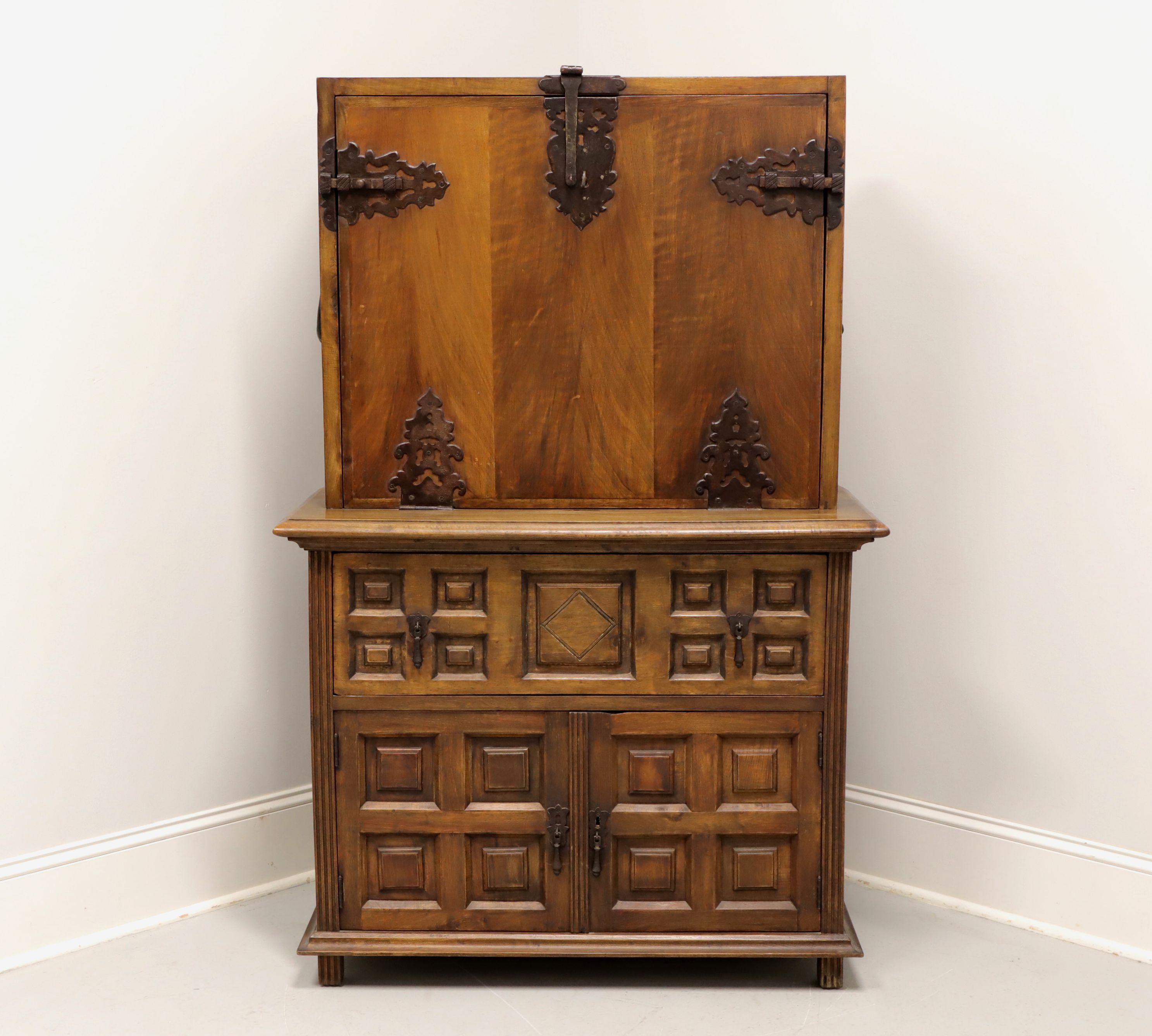 An antique Spanish style secretaire desk, a match to one found in the collection at The Hemingway House in Key West, FL, USA; unbranded. Solid walnut with iron hardware. Upper is the drop down desk surface door with decorative iron hinges, slide