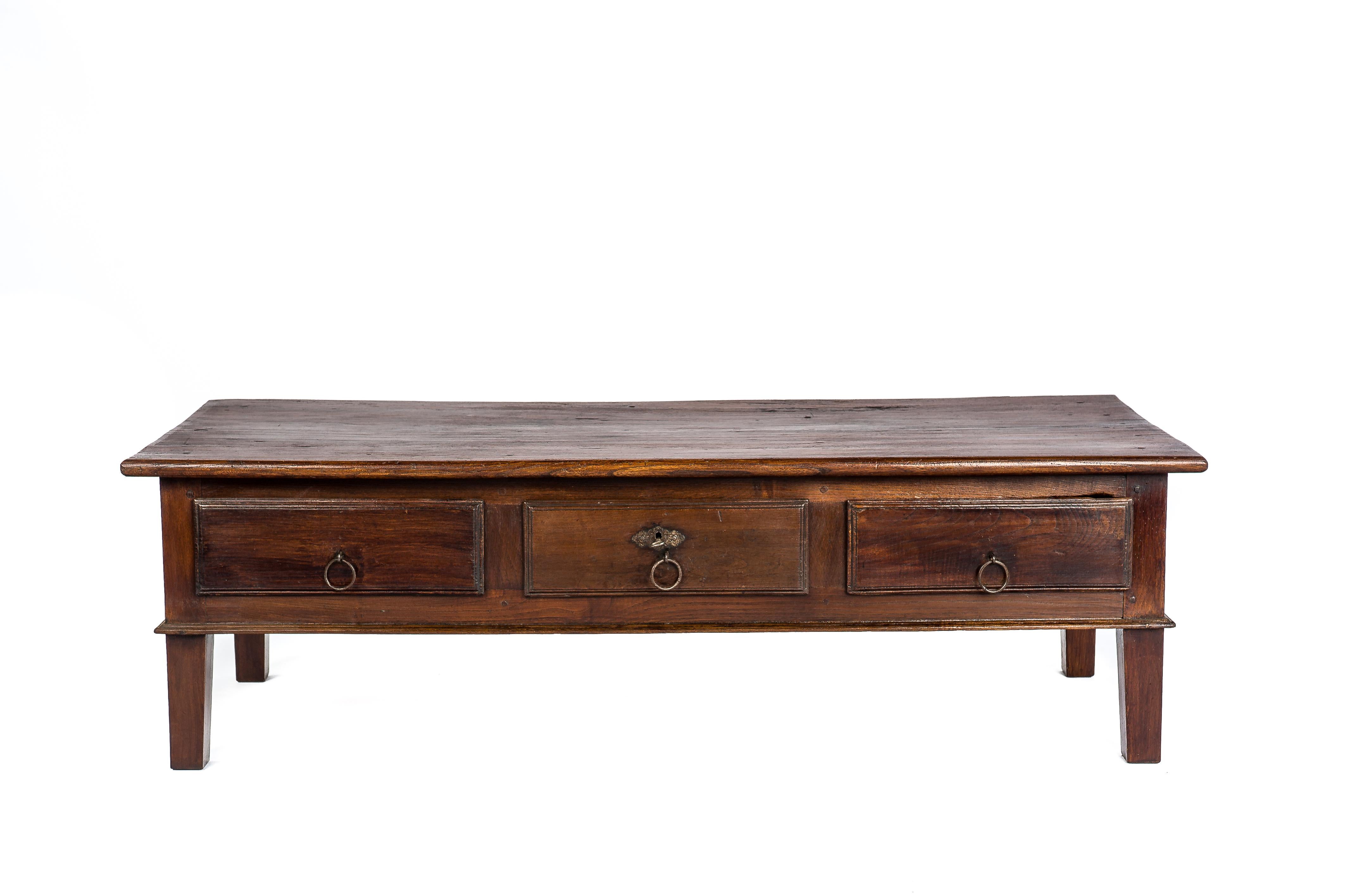 This beautiful warm brown rustic coffee table or low table originates in Spain and dates circa 1850. The table has a beautiful top that was made from a single board of solid elm and displays a wonderful grain pattern. The top has a beautiful patina