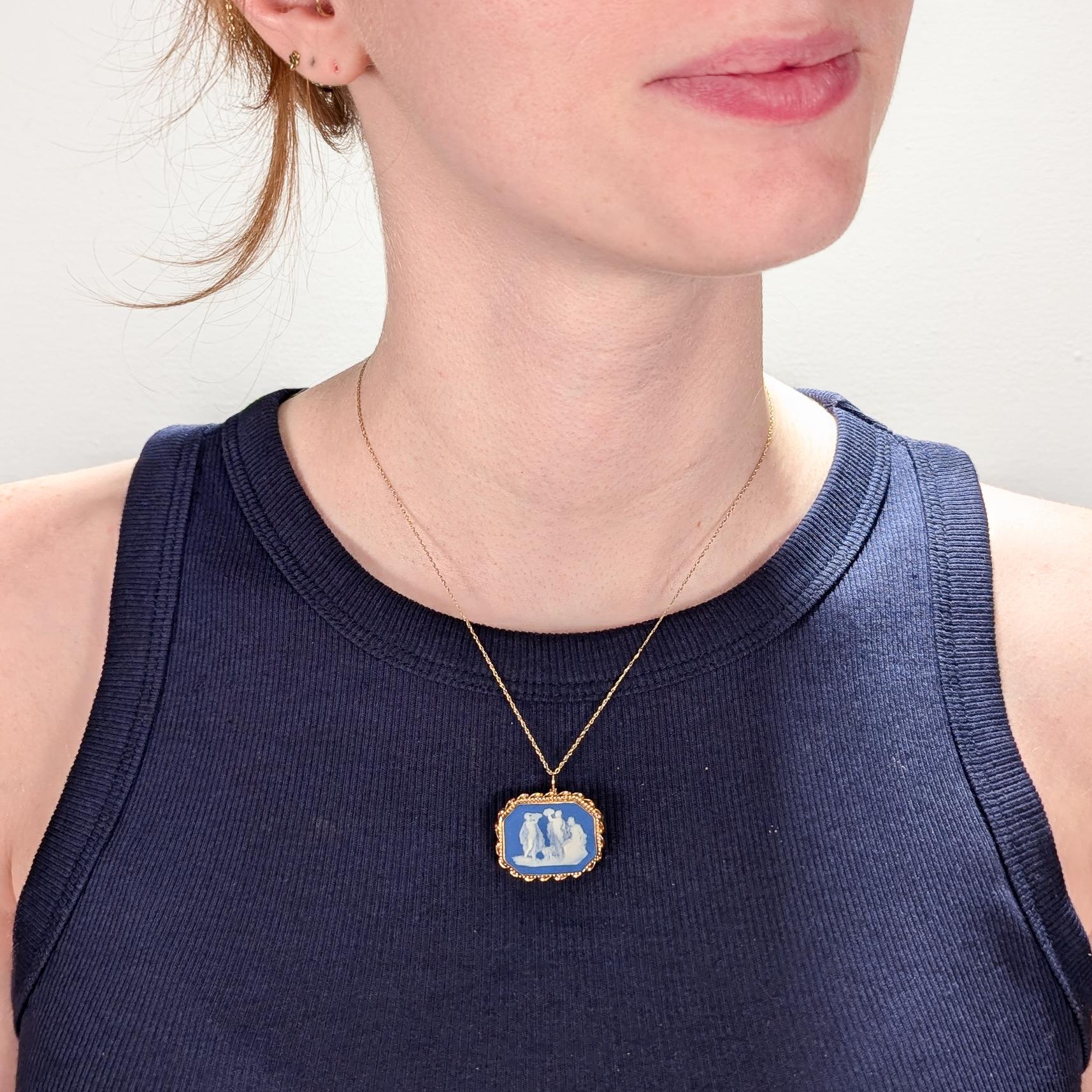 A wonderful antique Wedgwood blue jasperware and 14k gold pin and pendant combination.

The early 19th century plaque was finely bezel set in 14k gold in the early to mid 20th century by a clearly capable jeweler. 

It can be worn both as a brooch