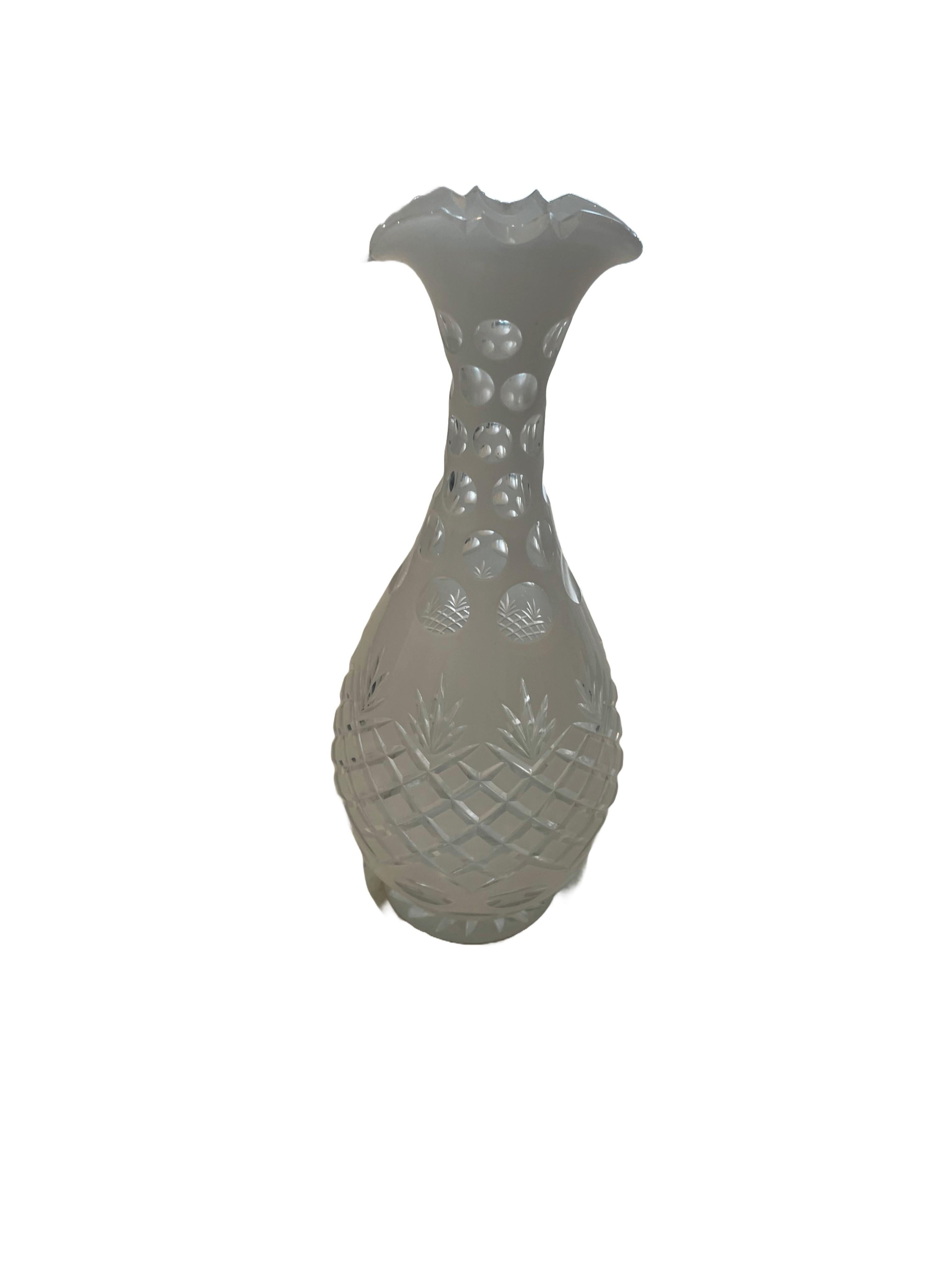 Made by the Bohemian Art Glass manufacturers of the 19th Century, this, Cut-to-Clear glass with white opaline glass overlay is hand-cut in a whimsical pattern that is harmonious with its contoured shape. This decorative piece is ideal as a vase.