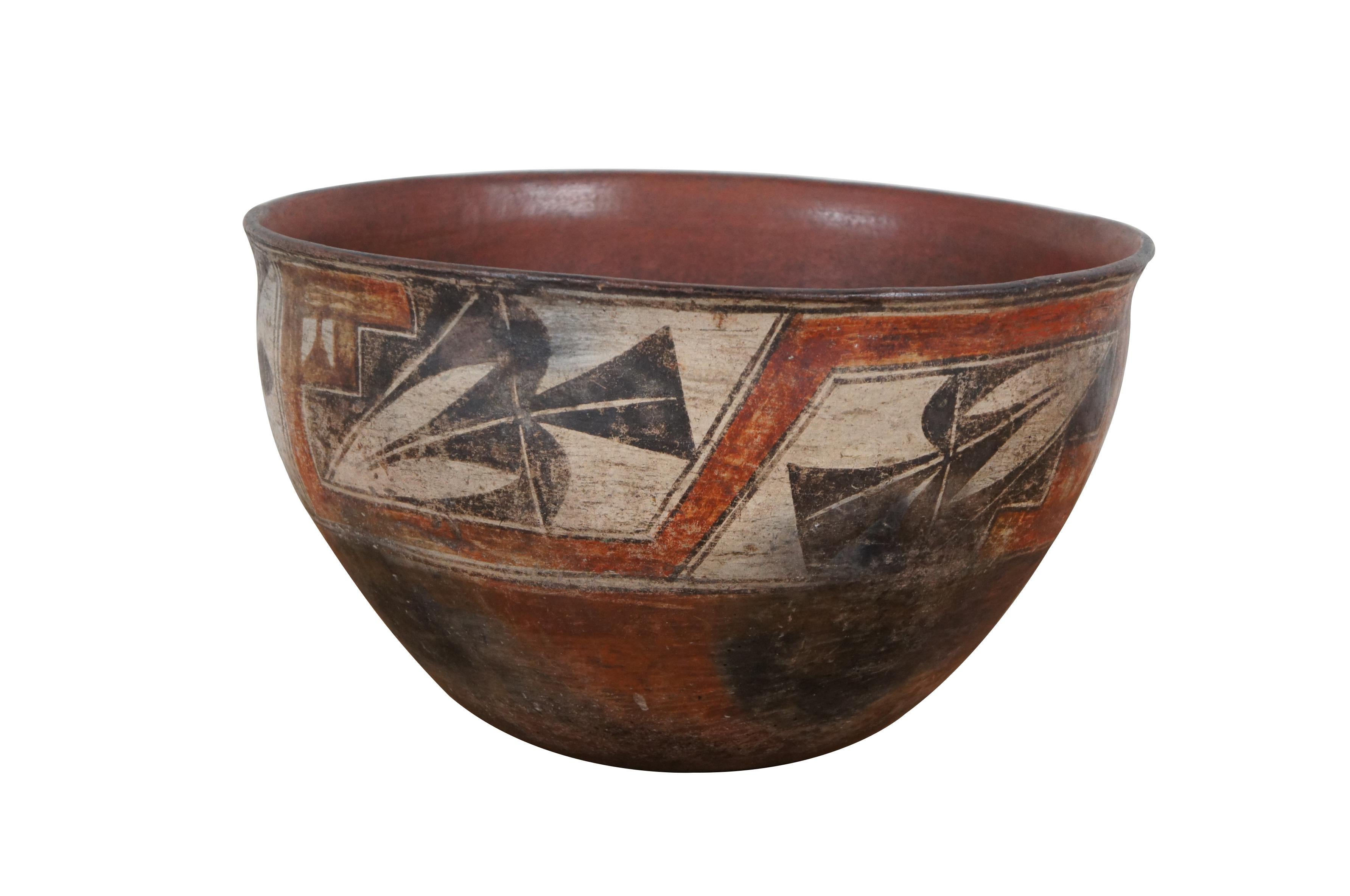 Very large and impressive, circa 1880's, Zia Pueblo polychrome dough bowl. Round shape with slightly tapered base, crafted of red clay, decorated with a band of red, white, and black geometric motifs.

The Zia Pueblo, situated atop a basalt mesa in
