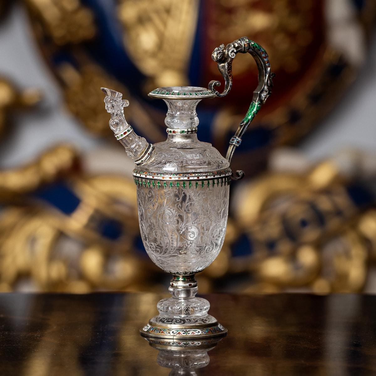 Antique 19th Century Austrian rare and unusual solid silver-gilt & enamel rock crystal ewer. The rock crystal engraved with chimeras among scrollwork, silver gilt mounts pierced and enamelled. The caryatid scroll handle with satyr head terminal.