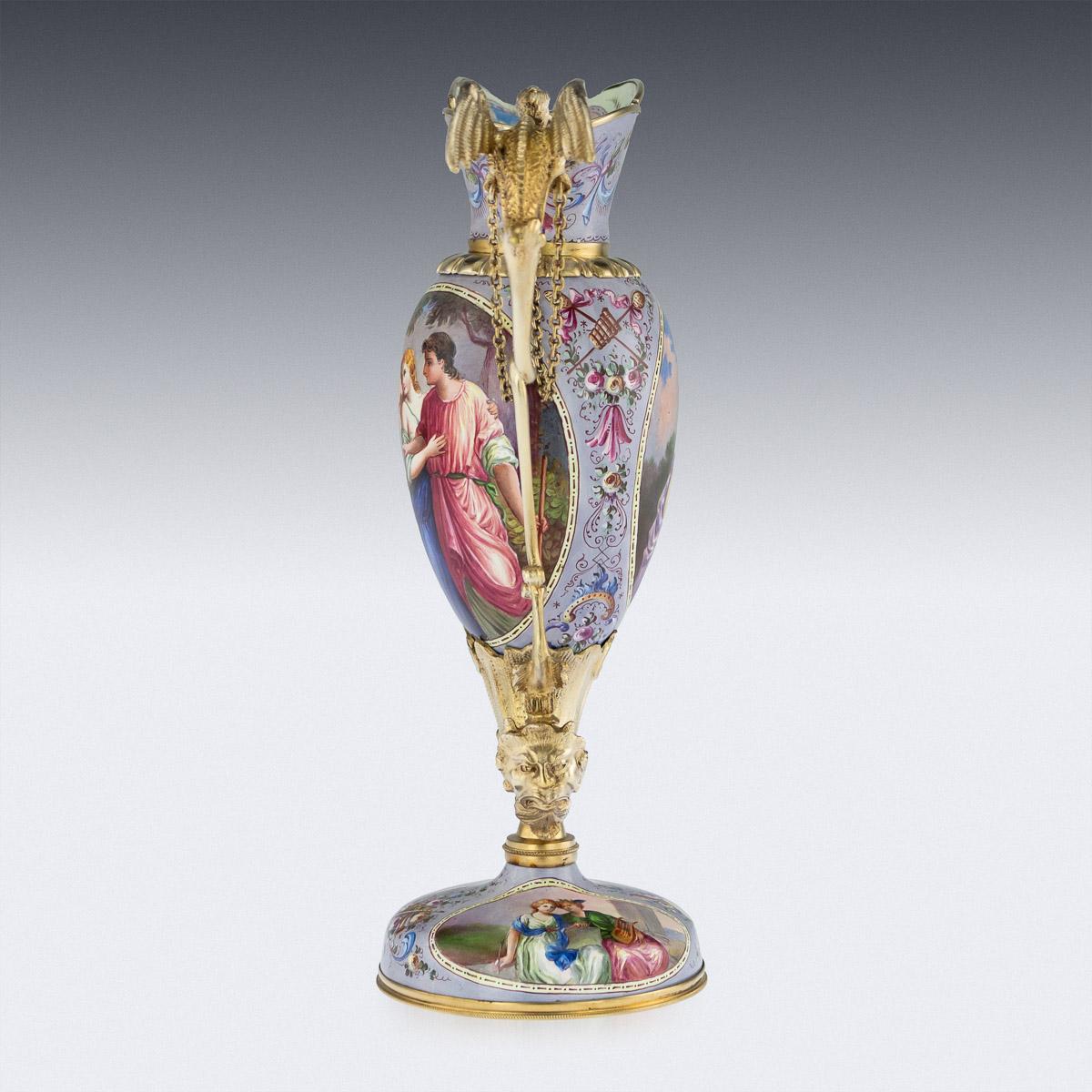 Antique late 19th century Austrian exceptional solid silver-gilt and enamel ewer, standing on a domed base, the hand painted enamel body supported with an acanthus leaf cornucopia and terminating with a satires head, resting a twist handle mounted