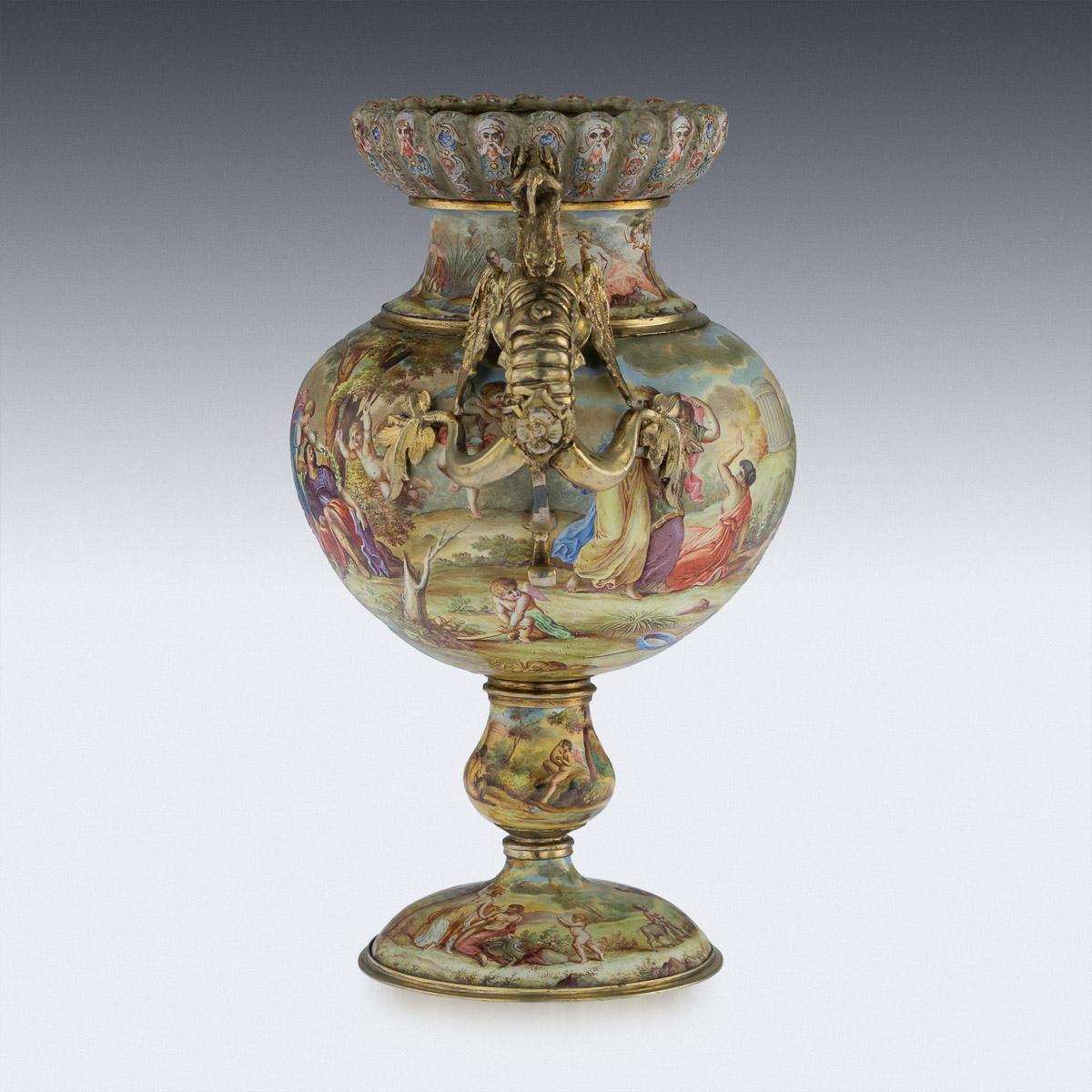 Antique late 19th century Austrian exceptional solid silver gilt and enamel twin handled vase, standing on an oval base, shaped bulbous stem and the body hand painted with classical allegorical scenes, sides applied with cast hippocampus handles.
