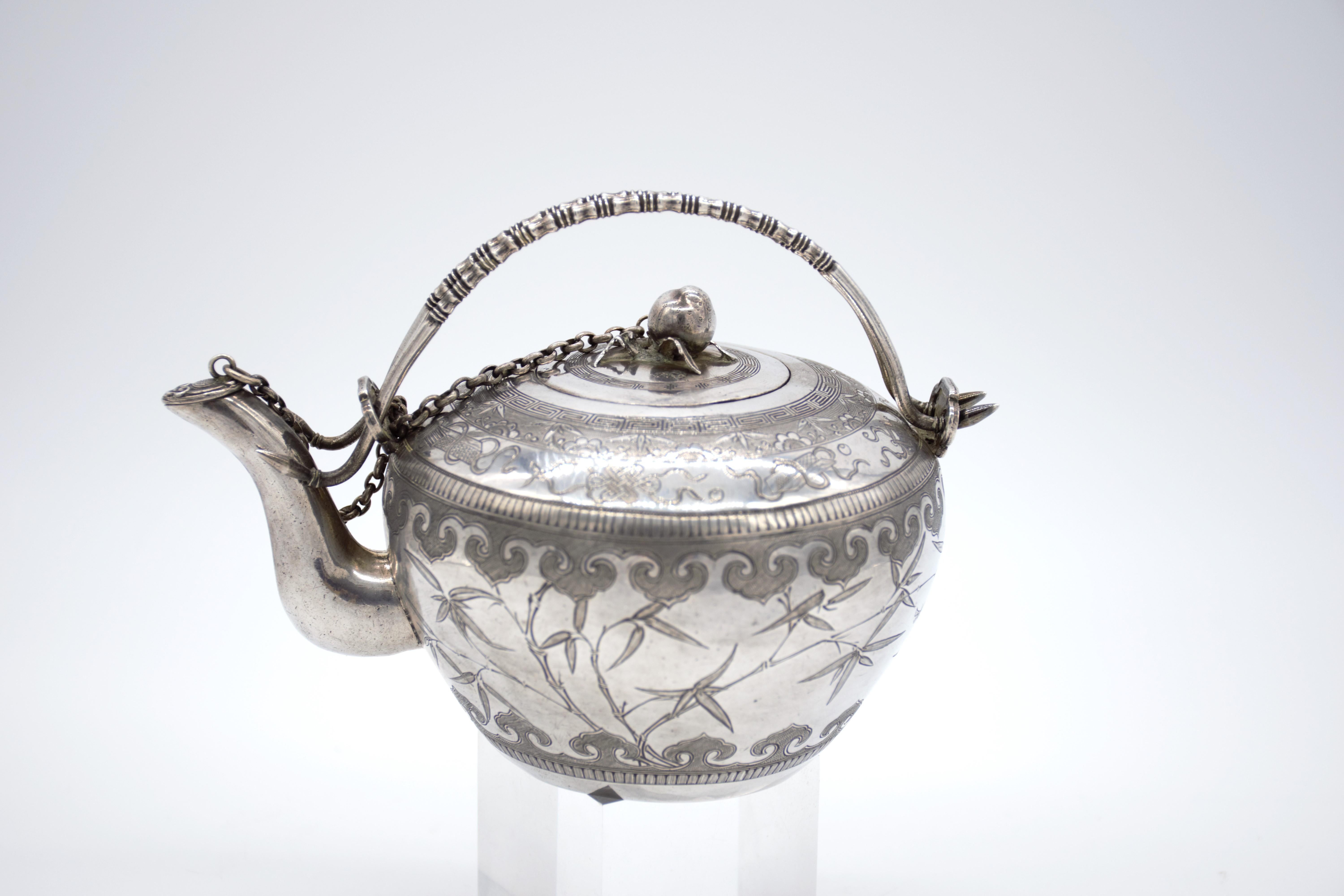 Antique early 20th Century exceptionally rare Chinese solid silver teapot, of traditional round form, the body finely engraved in traditional Chinese style, suggesting this teapot was made for the Chinese market. The body engraved with bamboo and