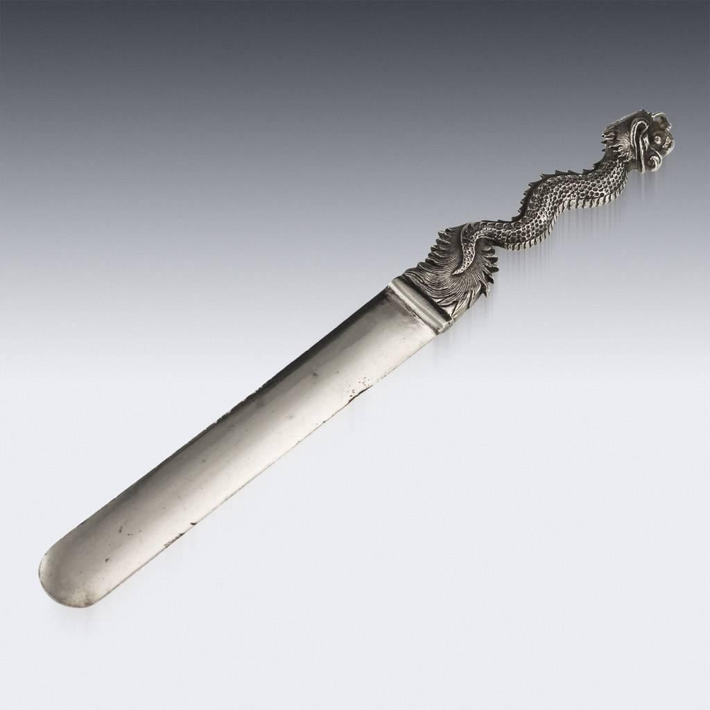 Antique late 19th century Chinese solid silver letter opener, applied with a cast dragon handle. Hallmarked with Chinese character marks, 90 (900+ silver standard), Maker De Chang, Retailed by WH, Wang Hing & Company, the most important and renown