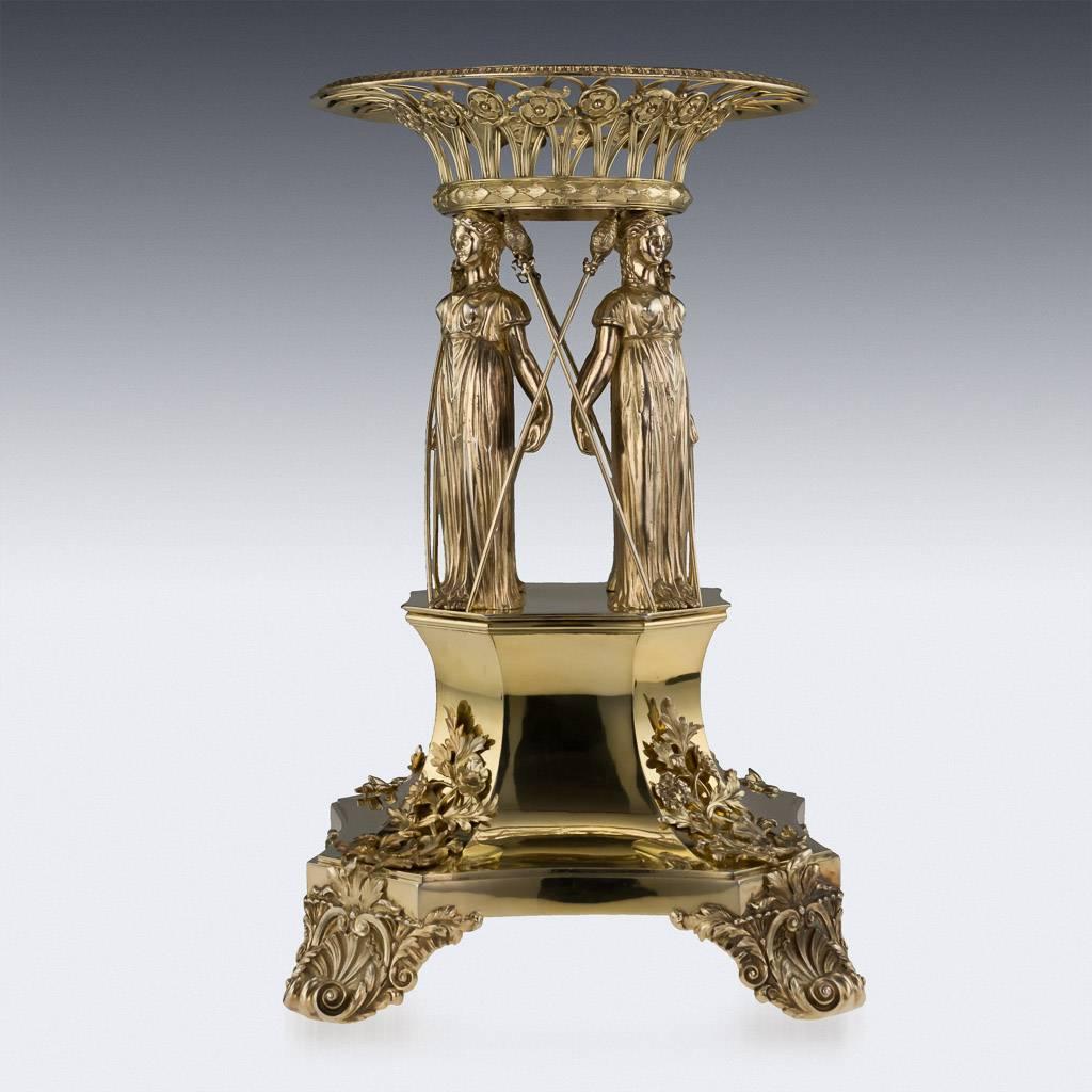 Antique 19th century Georgian Monumental solid silver-gilt figural centerpiece, the shaped square base on four cast and chased shell and foliate supports, engraved on either side with a coat-of-arms, the openwork stem of four classical female