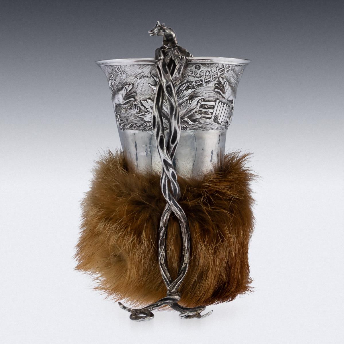 Antique 19th century Georgian solid silver stirrup cup, of very unusual design, the cup is cone shape, resting on twisted vines and mounted with a model of a fox, the top boarder depicting hunting dogs in a country landscape chasing a fox, large
