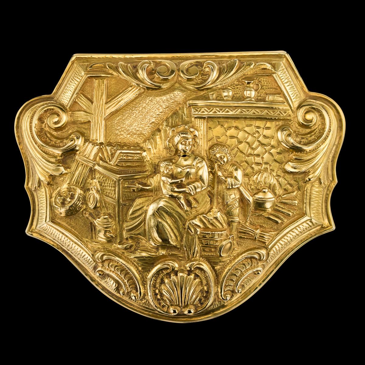 Antique mid-19th century German 18-karat solid gold snuff box, made in the style of the early 1720s boxes, cartouche shaped, chased with a scene dipicting possibly a Dutch lady being served tea by her Oriental servants, dressed in 17th century