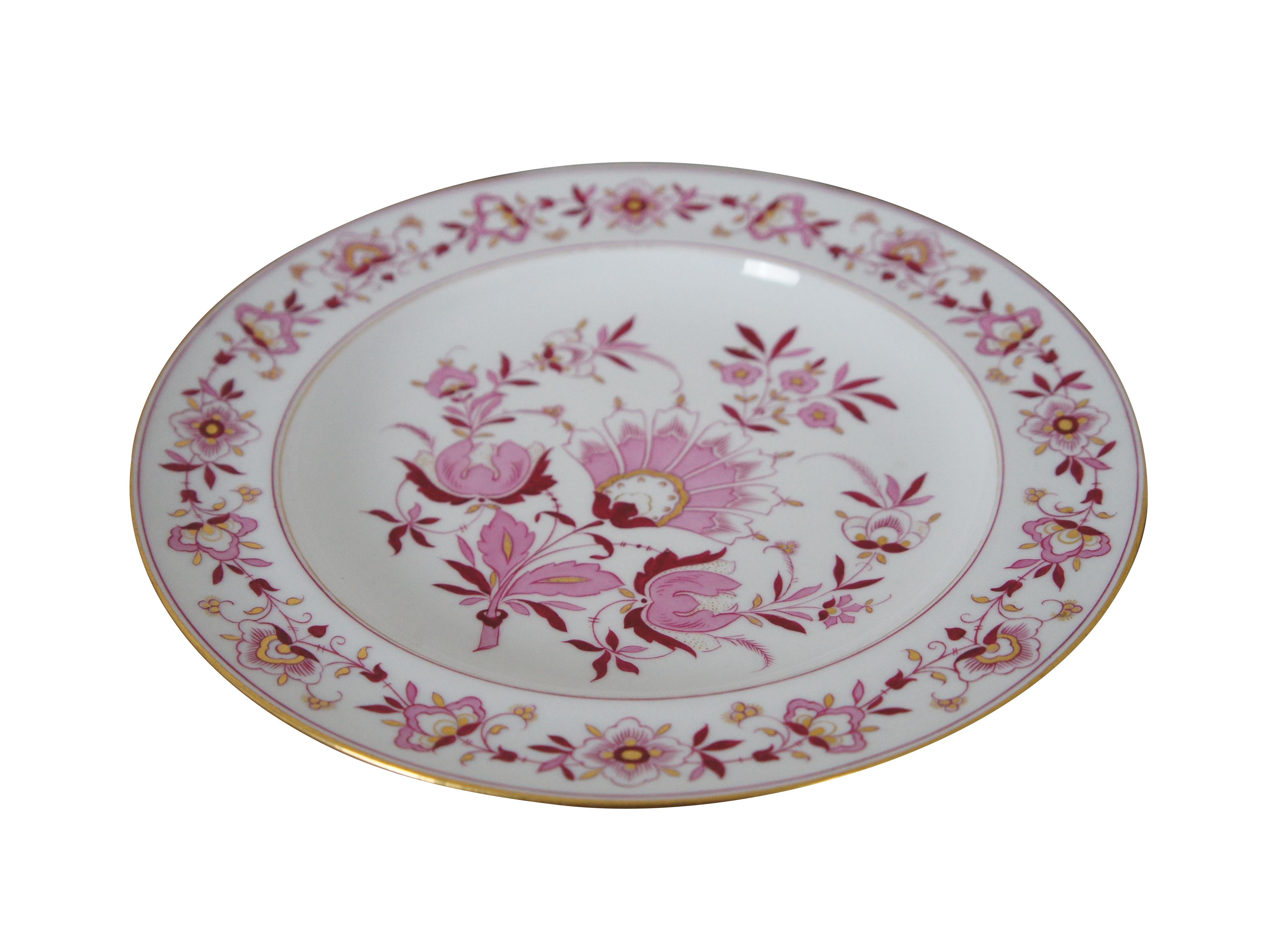 Antique Meissen dinner plate featuring a floral swag of flowers and central fan and the 1815 to 1860 crossed swords mark.

