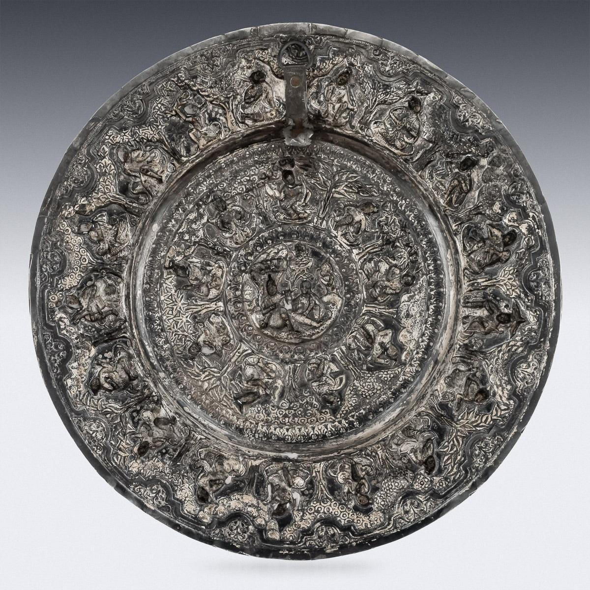 Antique late-19th century Indian solid silver dish, of impressive size, highly-decorative, embossed with various figures of deities, surrounded with bands of scrolling floral foliage, plain boarder and large bead boarder. The dishes distinctive