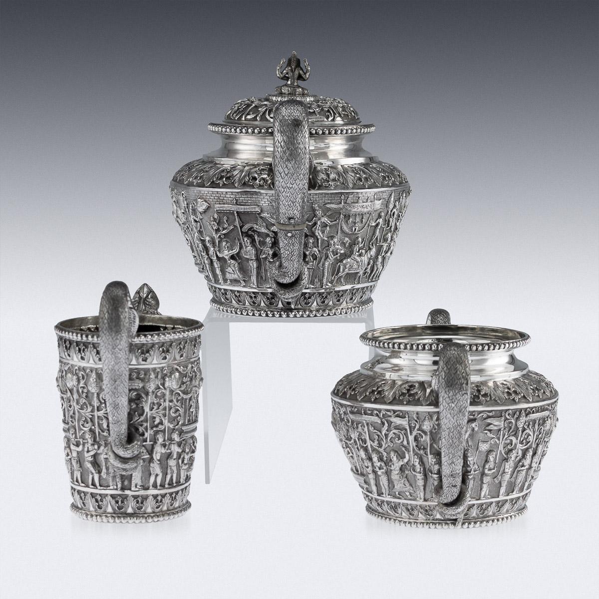 Antique 19th century Indian Colonial solid silver three-piece tea set, comprising of teapot, sugar bowl, & cream jug, each straight tapered body is profusely and beautifully repousse' decorated with a religious processions with men carrying idols, a