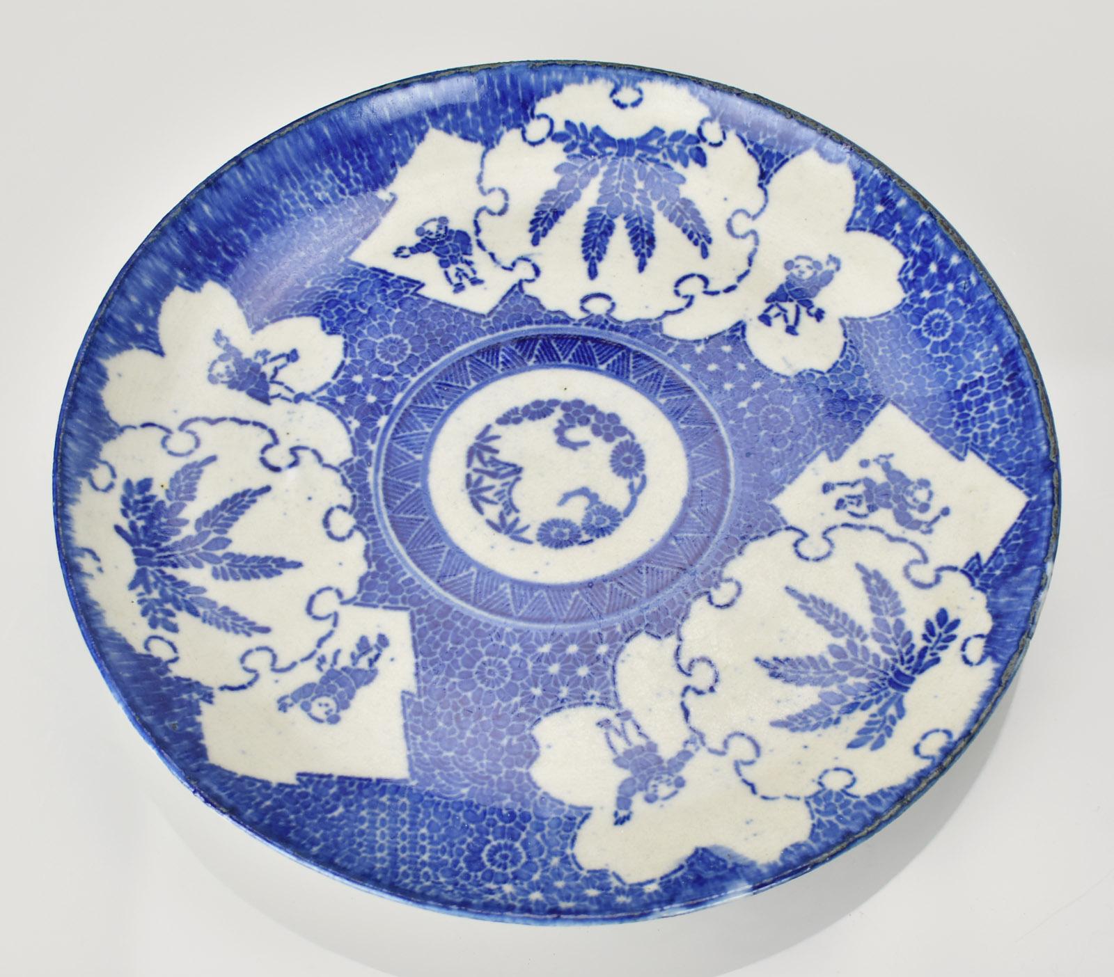 This antique Japanese Imari porcelain plate charger dates to the Meiji period, circa 1880. It showcases a stunning blue and white chintz pattern with detailed floral and scrollwork motifs, capturing the refined artistry typical of Japanese exports