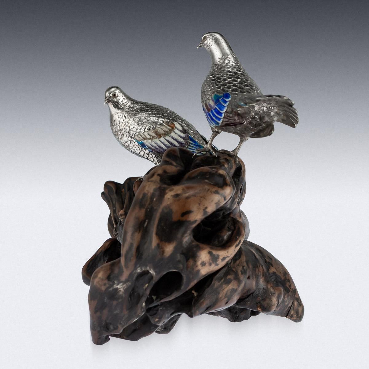 Antique late 19th century Japanese Meiji period very fine silver figures of wild wood pigeons, on a carved wood Stand. The naturalistically modeled birds decorated with enameled eyes and plumage, with realistically engraved feathers. Tested to be