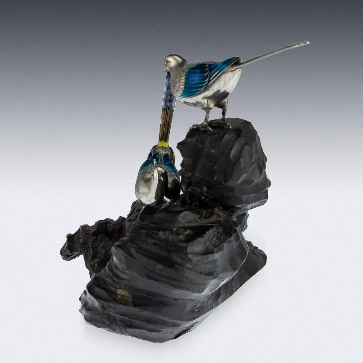 Description

Antique late 19th century Japanese Meiji period very fine silver figures of wagtails, on a carved wood stand. The naturalistically modeled birds decorated with enamelled eyes and plumage, with realistically engraved feathers. Tested