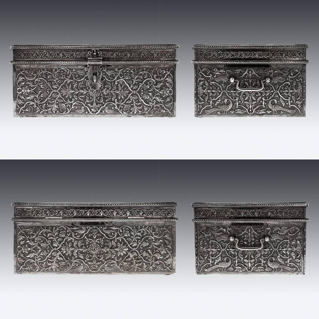 Antique 19th century rare Indian solid silver treasure chest or casket, massive size, of rectangular form with hinged lid, foliate lock and hinged handles, profusely repousse' decorated with scrolling foliage on a matted ground, the lid featuring a