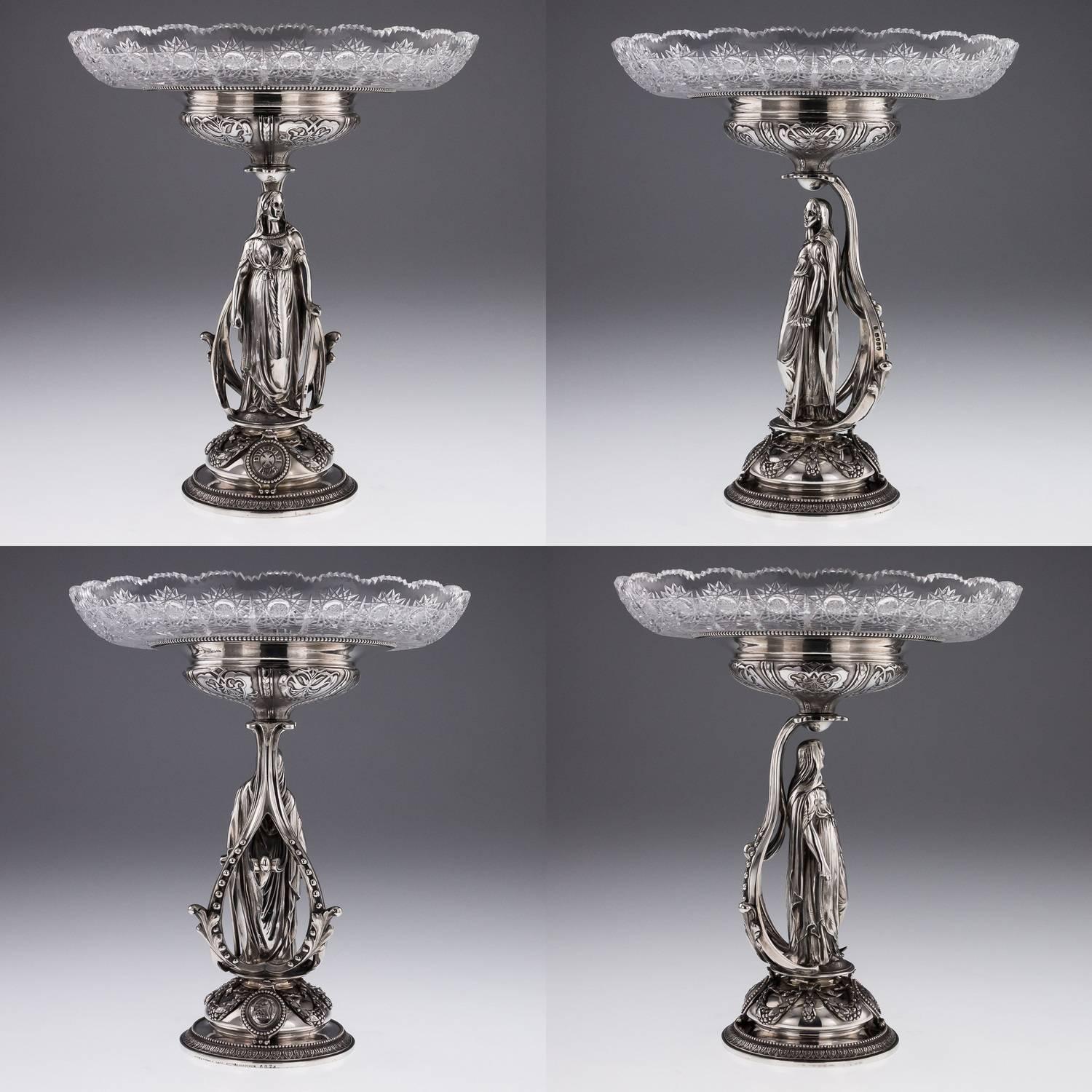 Description
Antique 19th century magnificent and unique pair of Victorian solid silver figural comports, each piece raised on a circular domed base chased and applied with swags and cast armorials, each stunning figural stems modelled like a large