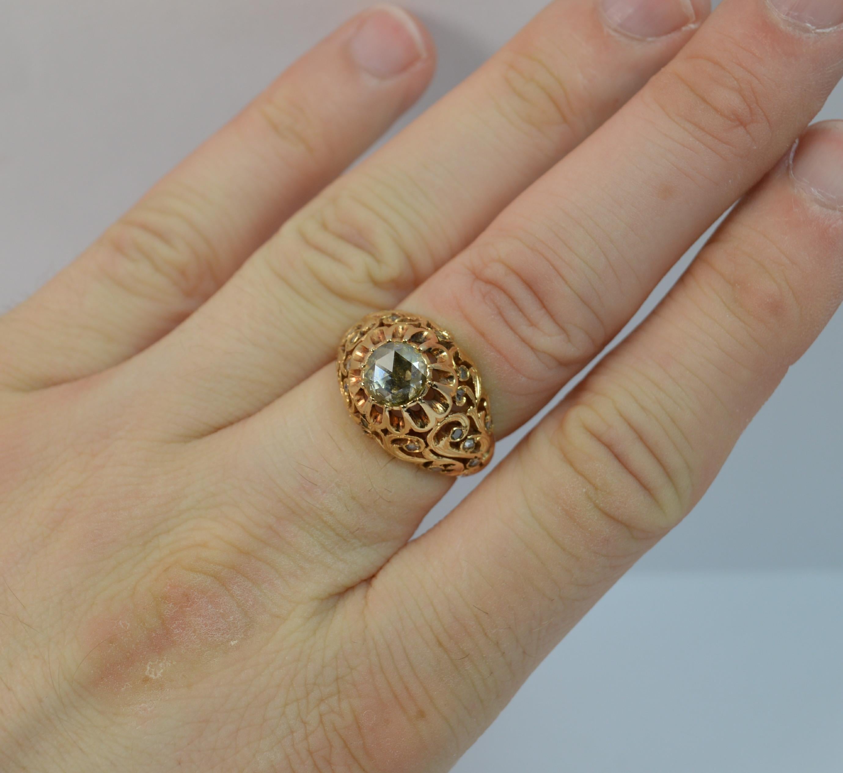 A fantastic Diamond and 18ct Rose Gold ring.
SIZE ; N UK, 6 3/4 US
Designed with a 6.4mm diameter rose cut diamond to the centre in bezel setting. Surrounding is a finely pierced pattern with small rose cut diamond chips throughout.

The centre