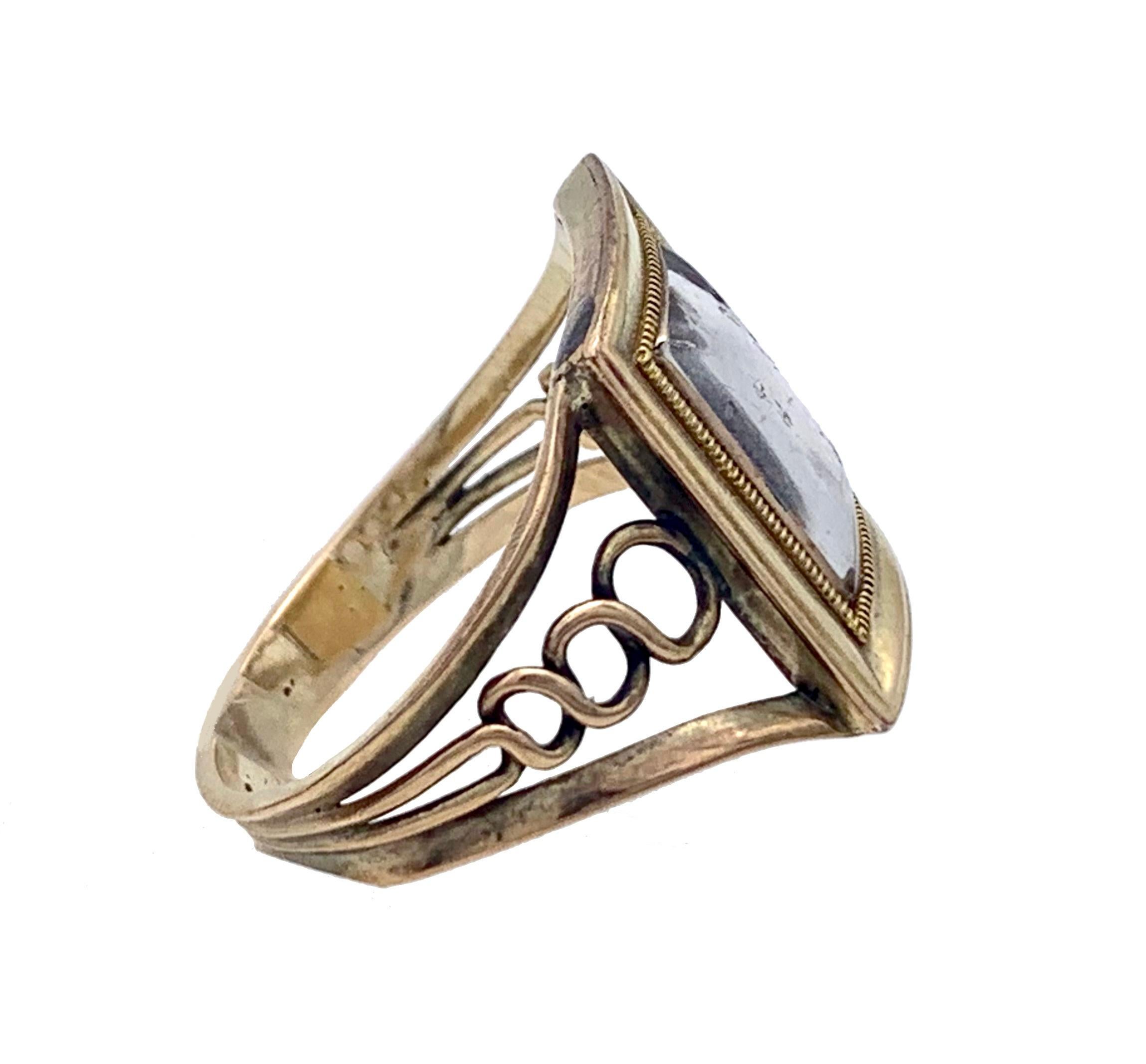 This unusual shaped gold ring wast created out of 9 karat gold in the 1st decade of the nineteenth century, over 22o years ago..
Basing my judgement on rings of this period with almost identical shanks carriing a dated inscription, I dare narrow