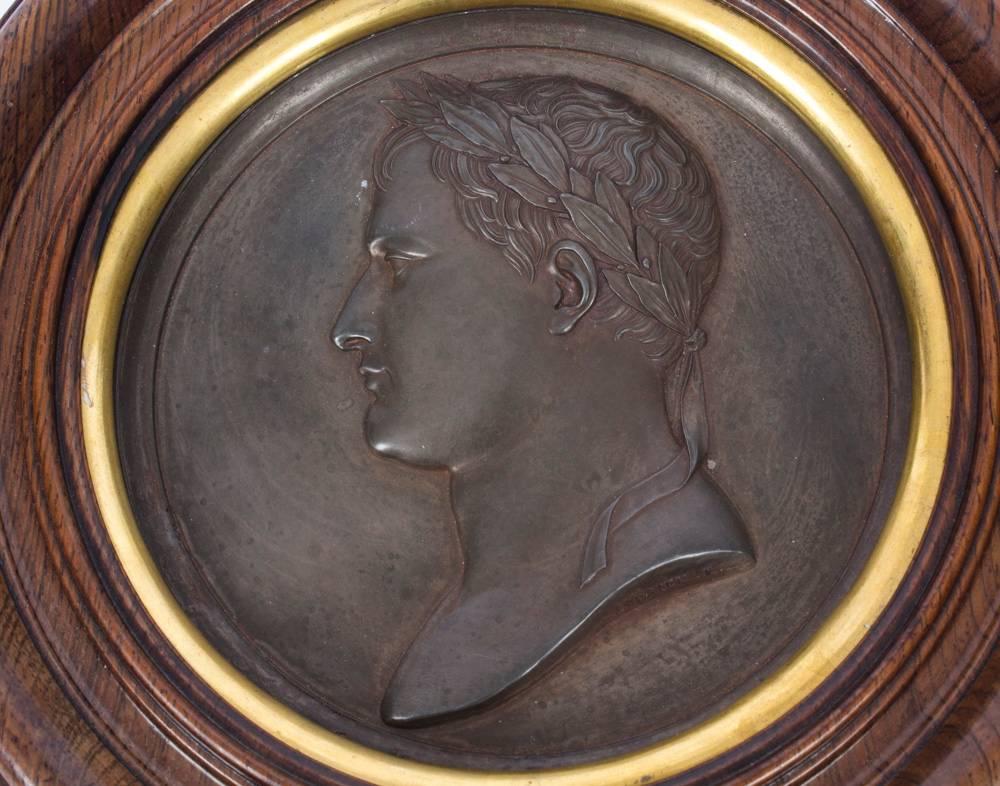 This is a fine first Empire bronze plaque of Napoleon Bonaparte, signed on the border Andrieu. F and dating from the late 18th century.
 
The relief bust profile is of a young Napoleon wearing a classic laurel wreath symbolizing honour and victory