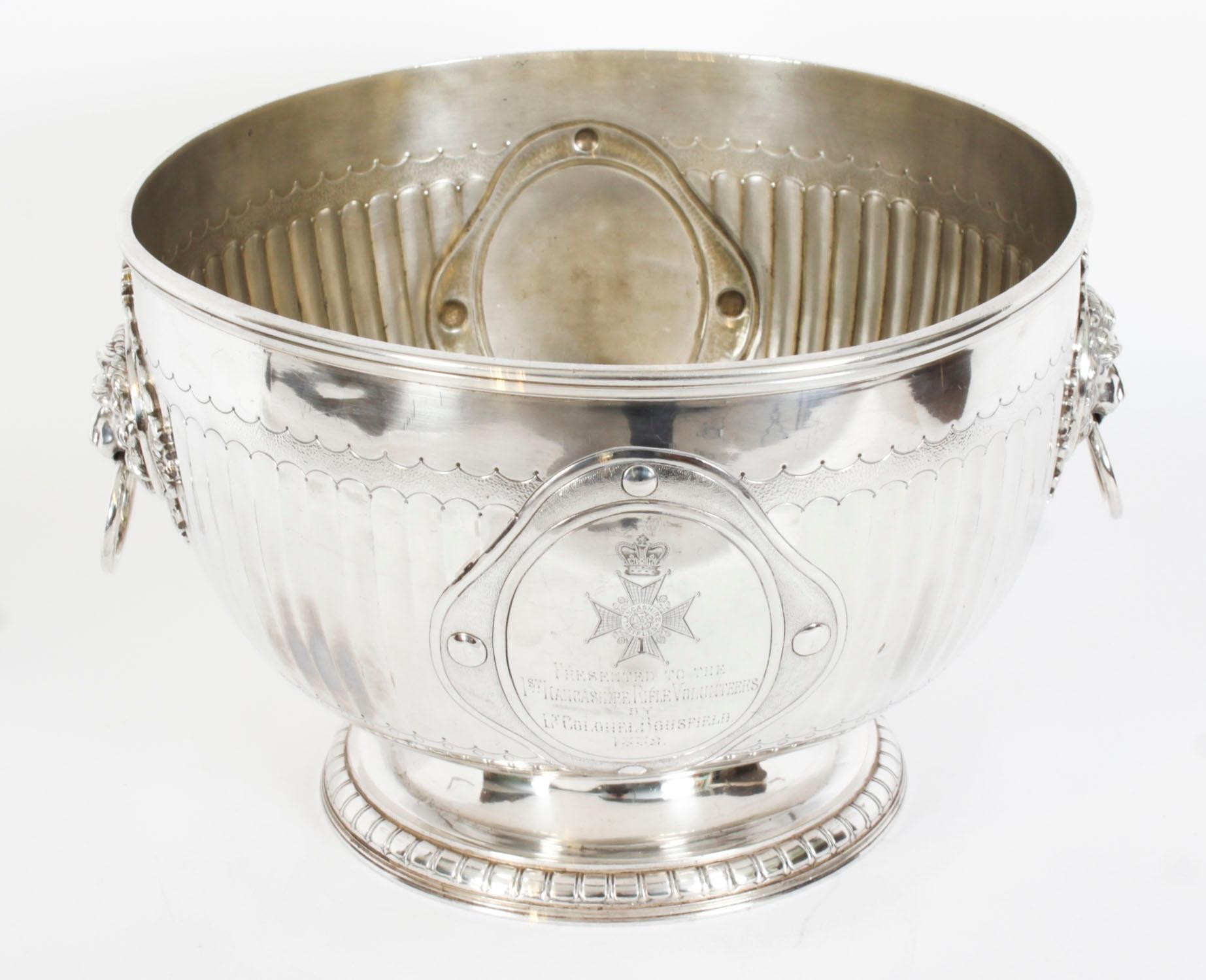 This is an exceptional antique English Neo-classical Revival silver plated wine cooler bearing the makers mark of the renowned English silversmith Elkington, dated 1873.

The wine cooler is raised on a circular pedestal base with a reeded body and