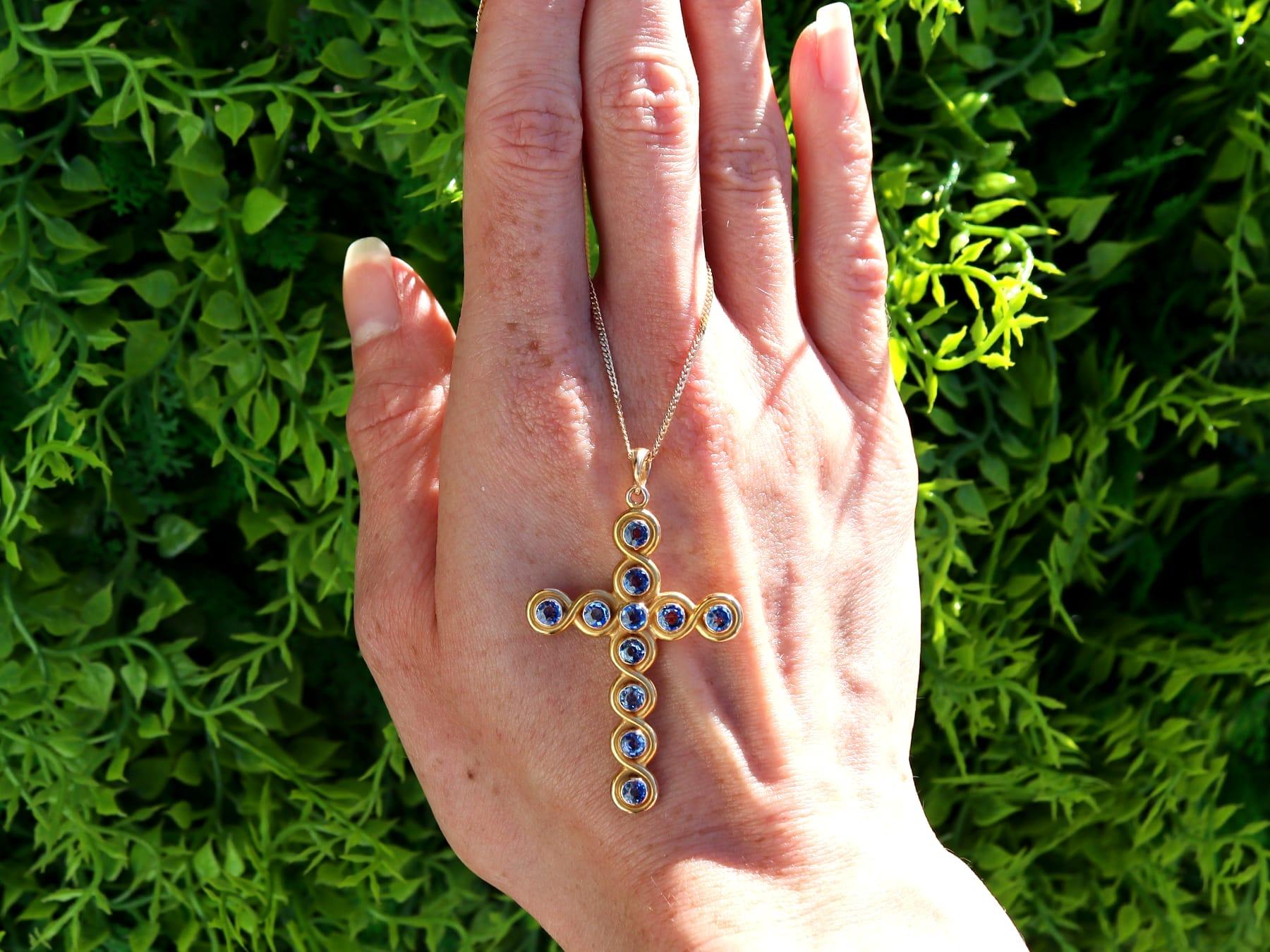 A stunning, fine and impressive antique 2.00 carat Montana blue sapphire and 18 karat yellow gold cross pendant; part of our diverse collection of antique cross pendants.

This stunning antique cross pendant has been crafted in 18k yellow gold.

The