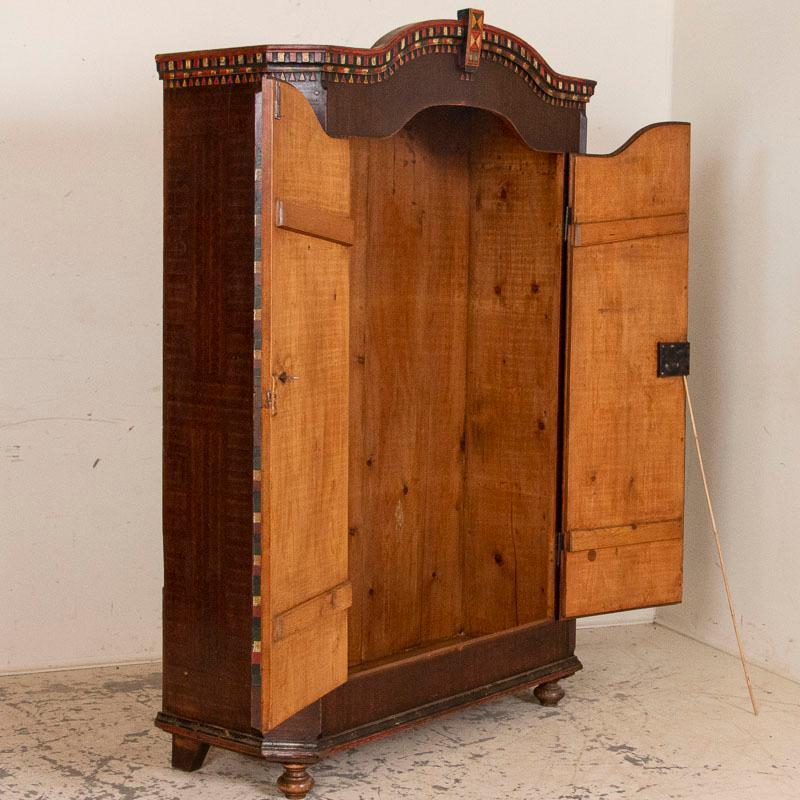 This is a truly outstanding painted armoire due to the high quality and detail of the original Folk Art paint. The vibrant paint colors and floral design were traditional Folk Art style elements during the 1800s, in Hungary. The casework is pine