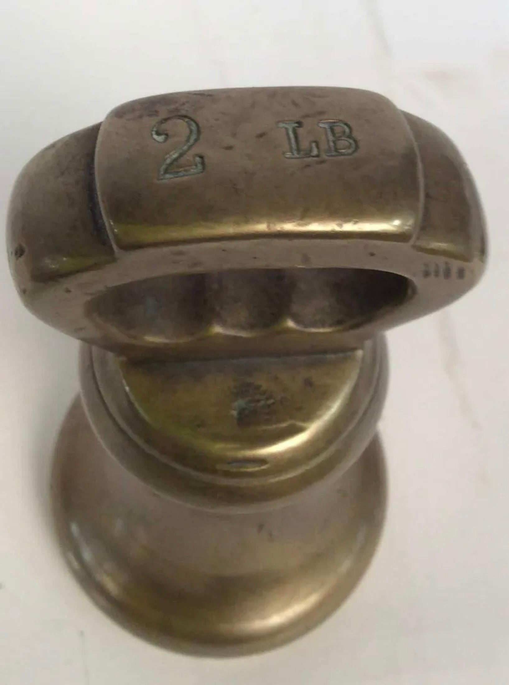 Antique bell shaped brass 2 LB grocers weight, marked 2 Lb on top. The weight can make a wonderful paper weight, decorative sculpture or door stopper.
Search terms: Antique brass weights, brass accessories, antique grocers utensils, decorative