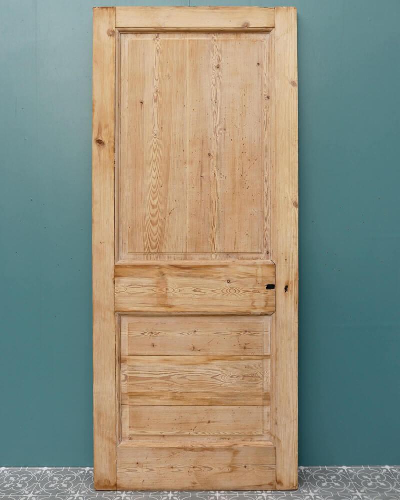 Une élégante porte ancienne en pin anglais à deux panneaux pour un usage intérieur datant du début du 20e siècle. Fabriquée en pin, cette porte de style victorien présente des panneaux en relief et à champs des deux côtés. Il est décapé et poncé,