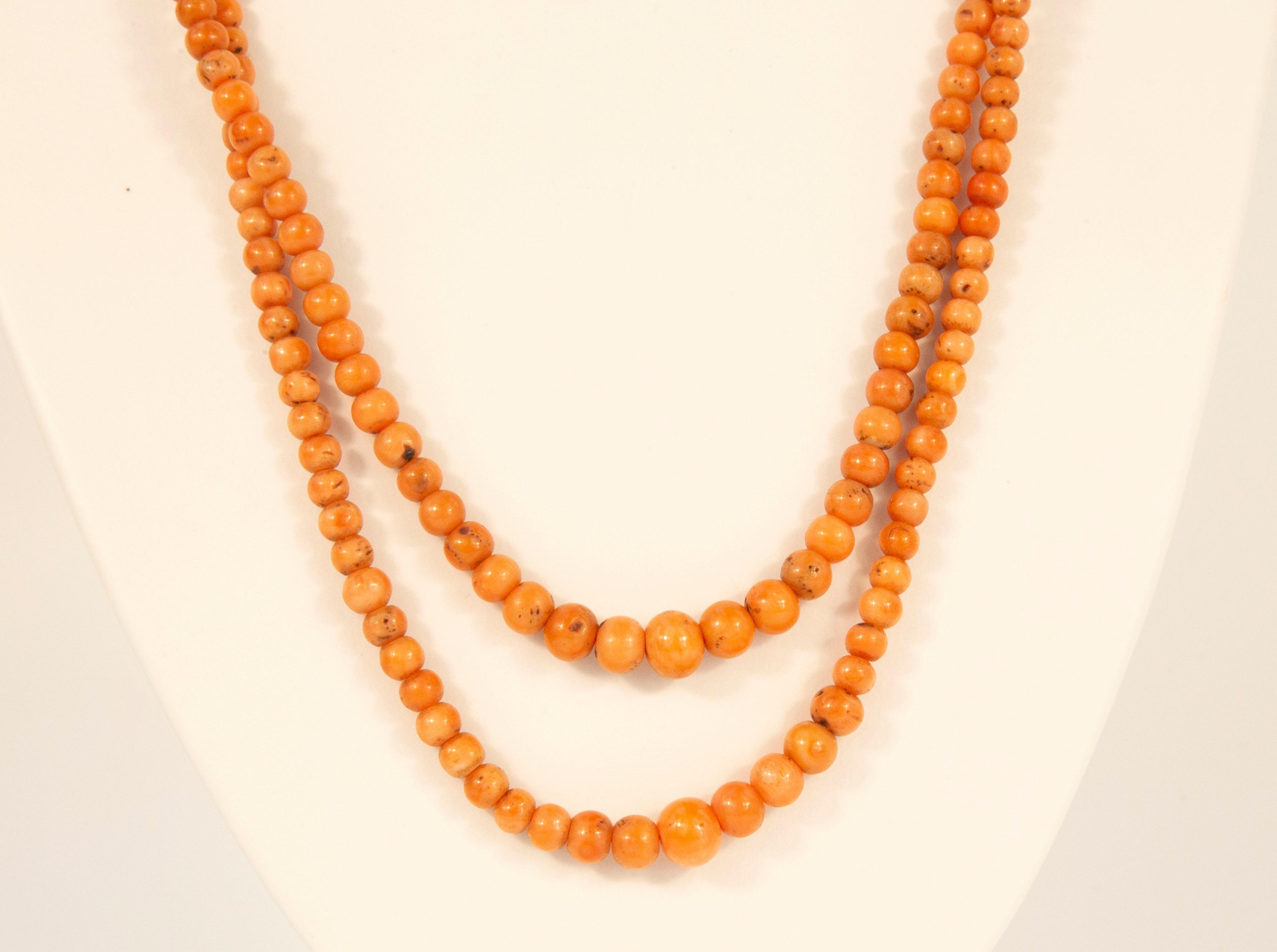 An antique 2-row genuine red coral (Corallium Rubrum*) graduated beads necklace with 14 karat yellow gold filigree closure. The necklace was made in the Netherlands in the early 1900s. The necklace has a middle length and optionally it could be worn