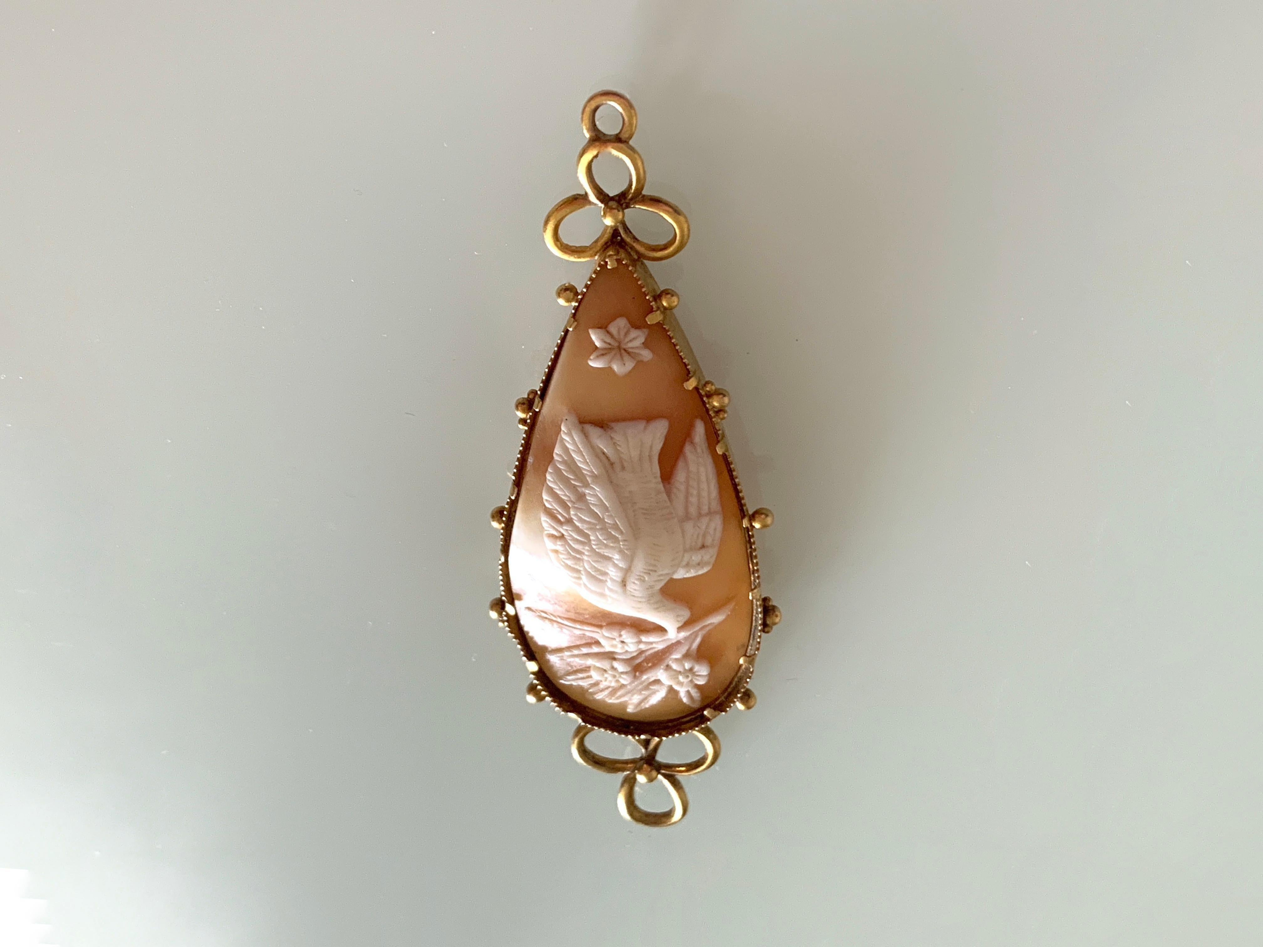 Beautiful Victorian Antique
Hand carved Cameo - depicting dove & foliage
held in a 20ct Gold Mount 
( slight movement - but very secure)
unmarked for gold 

Circa 1880s - 
Was possibly attached to a chain - with a pearl droplet 
which is not present
