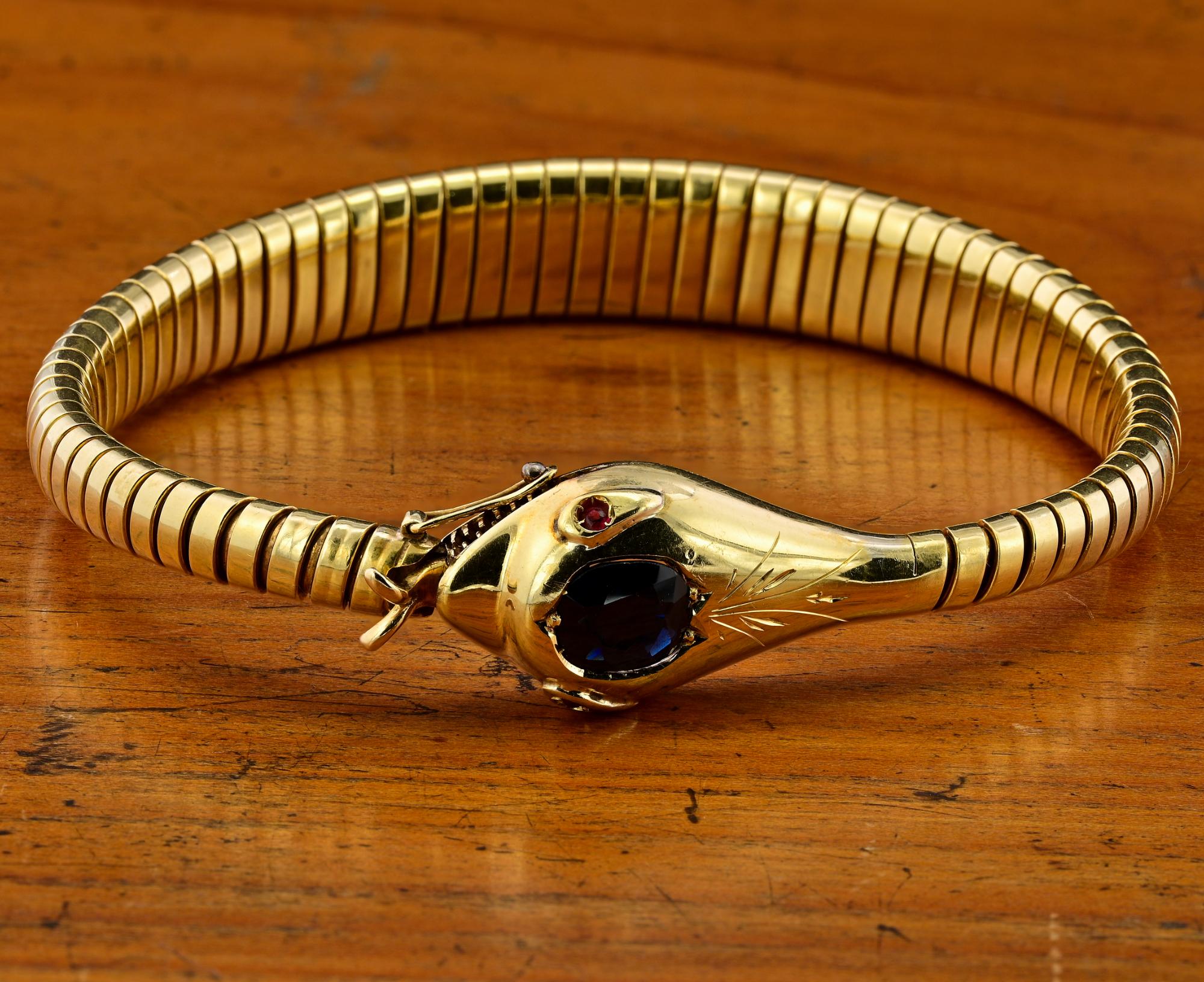 This fascinating Snake bracelet is 1920 circa
Hand crafted of solid 18 KT gold, Italian origin
Traditional past tubogas work terminating with Snake head – weighs 23.3 grams
Snake head is embellished by a superb intense Blue natural unheated Sapphire