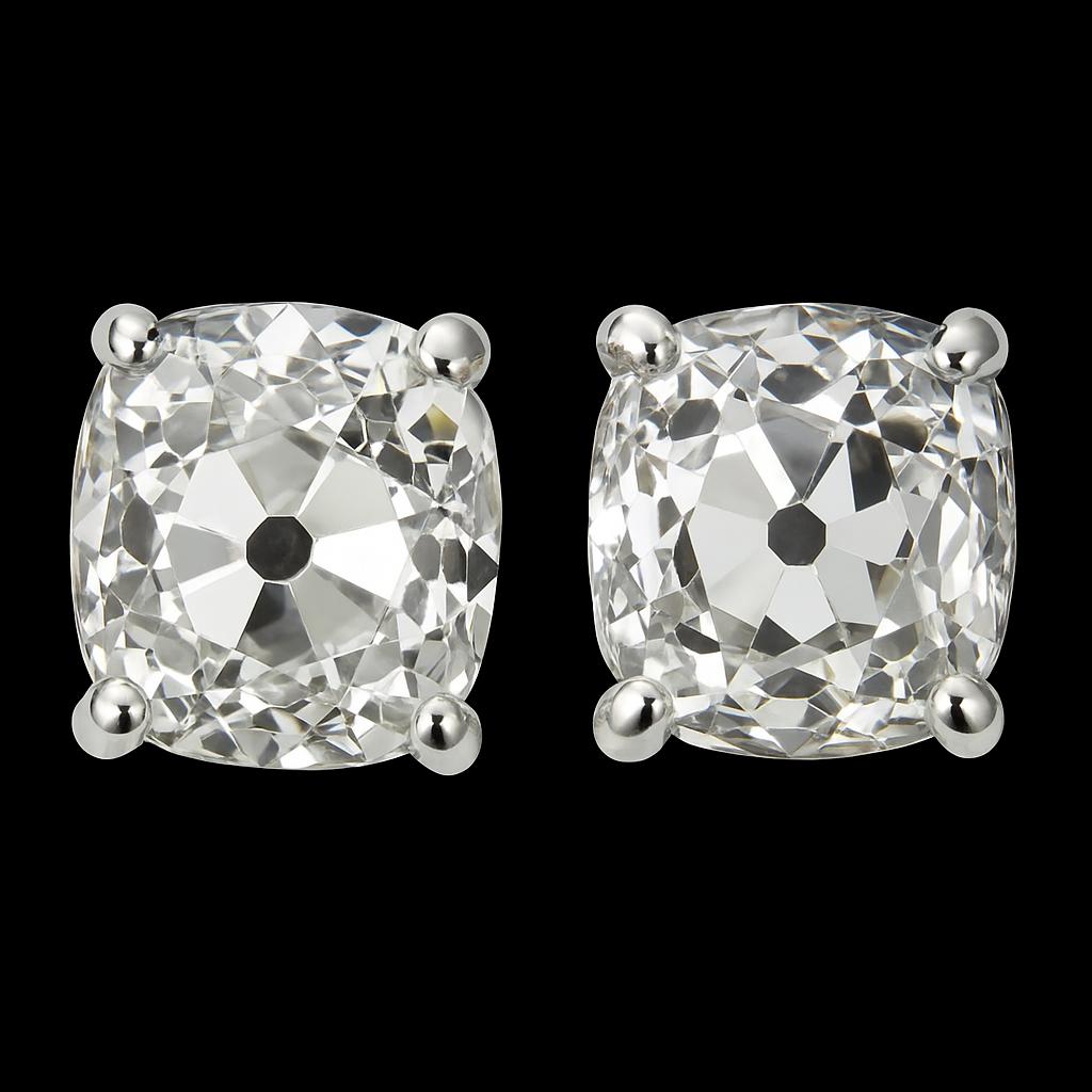 This elegant pair of antique diamond studs features two beautifully matched old mine cut diamonds with a combined weight of 2.20 carats. Expertly set in classic four-prong white gold mountings, each diamond showcases the distinctive charm of