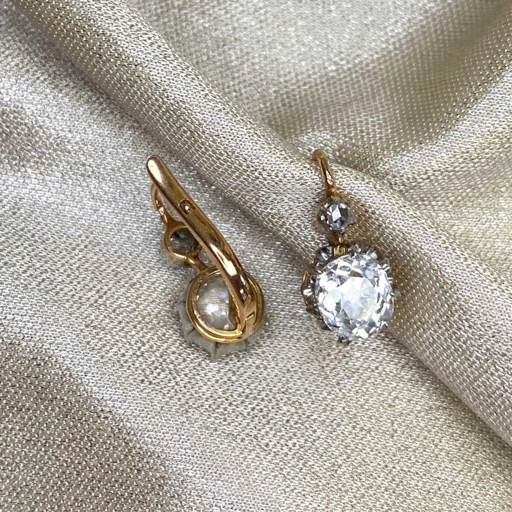 Experience the allure of the past with these antique 18k yellow gold earrings. Gracing each earring are antique cushion-cut diamonds, pristinely set and weighing a combined 2.00 carats. Their I-J color and VS2-SI1 clarity enhance their radiance.