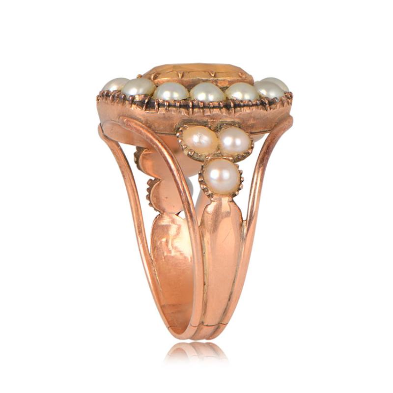Antique Citrine and Pearl Halo Ring: An exquisite antique ring featuring a 2-carat cushion-cut citrine gemstone at its center. The citrine is encircled by a rare halo of lustrous pearls, which also grace the ring's shoulders. This captivating piece