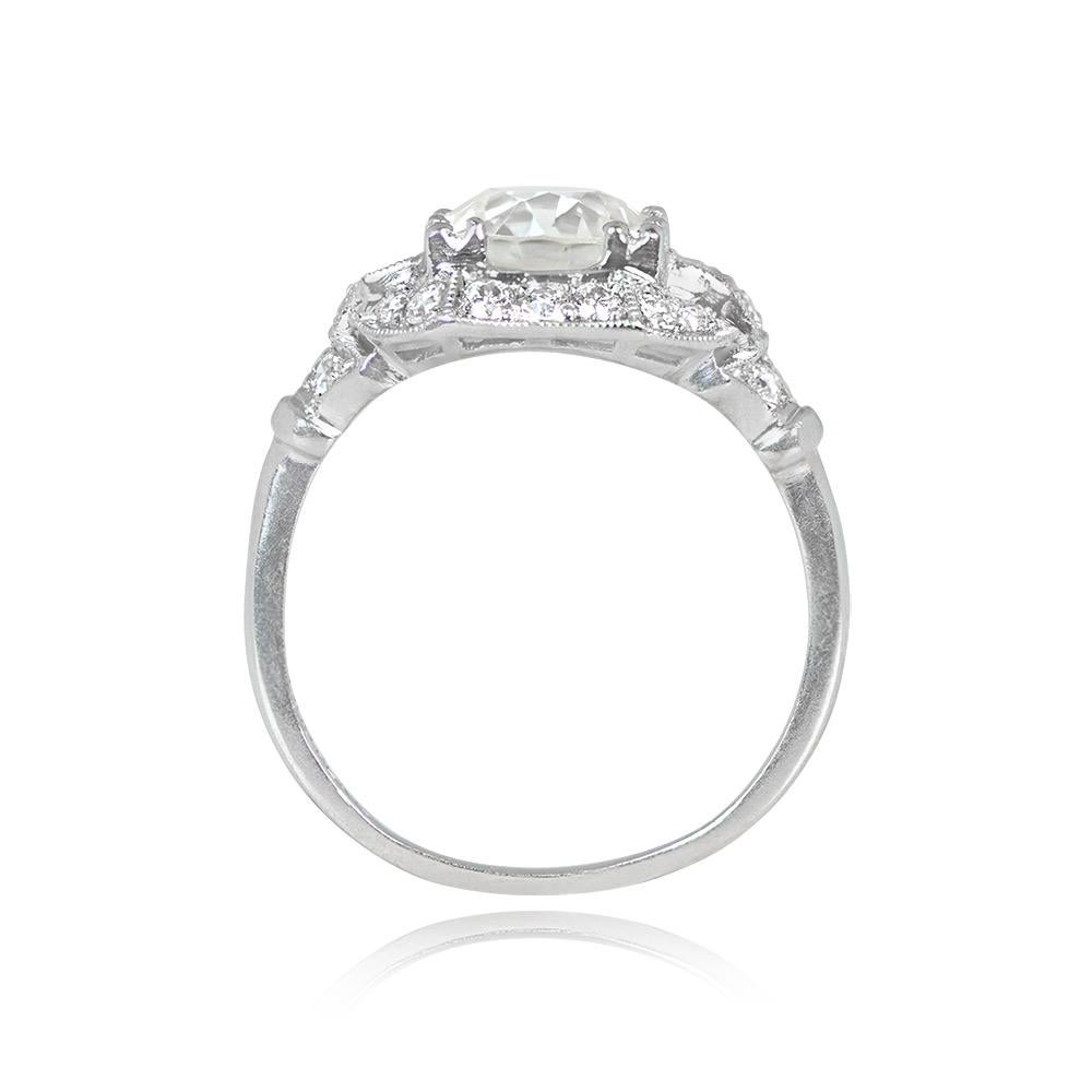 This antique ring showcases a 2.08-carat old European cut diamond with L color and VS1 clarity, set in prongs and accentuated by baguette-cut diamonds. The platinum mounting features delicate milgrain detailing and is adorned with a border of old